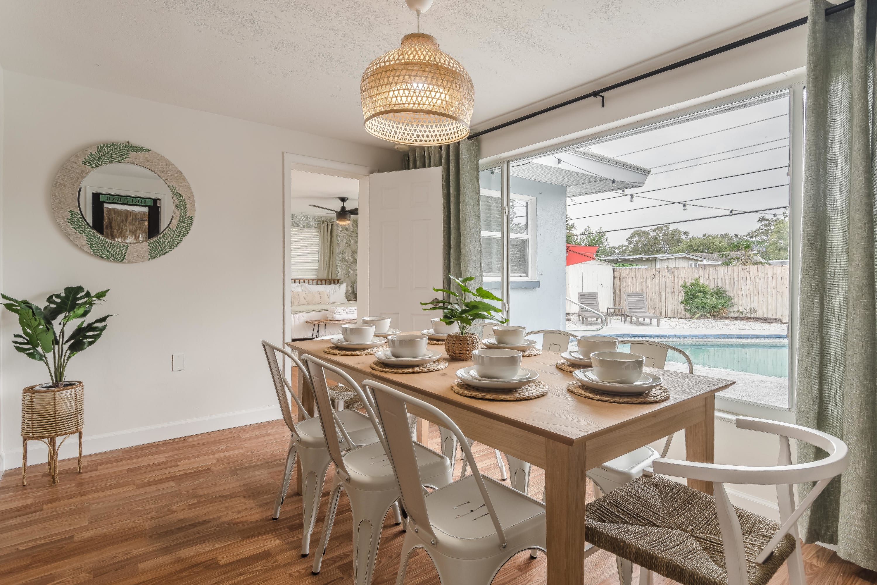 Casual dining area w/ warm wood floors and simple, airy style