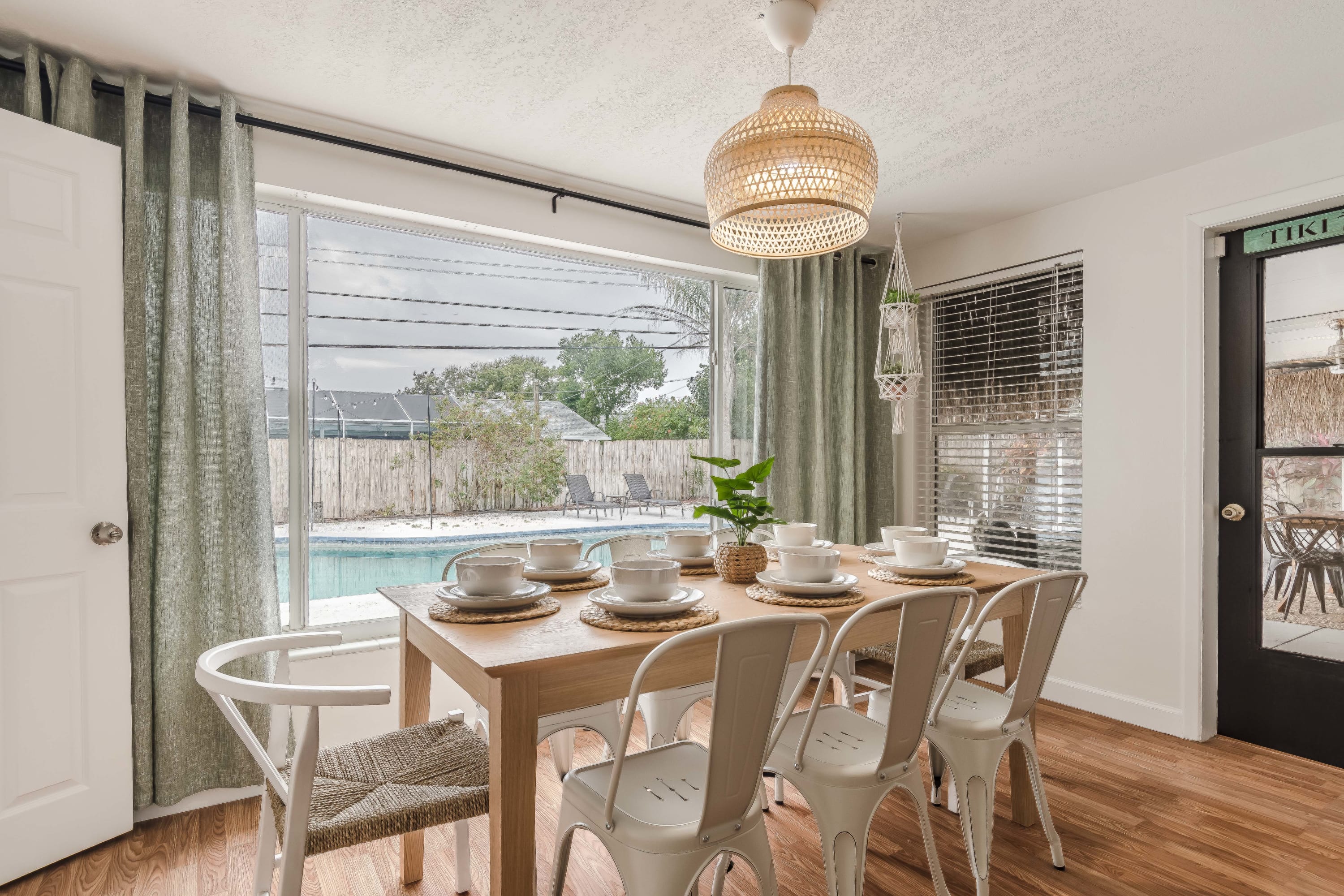 Dining area set by large windows for relaxed meals and conversation