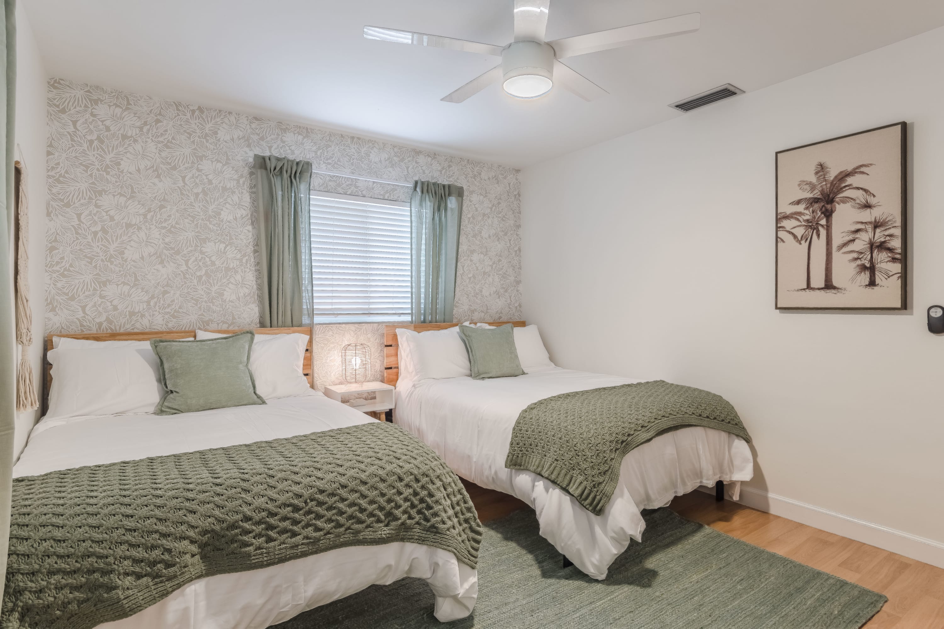 Cozy bedroom w/ layered bedding and calm, neutral tones
