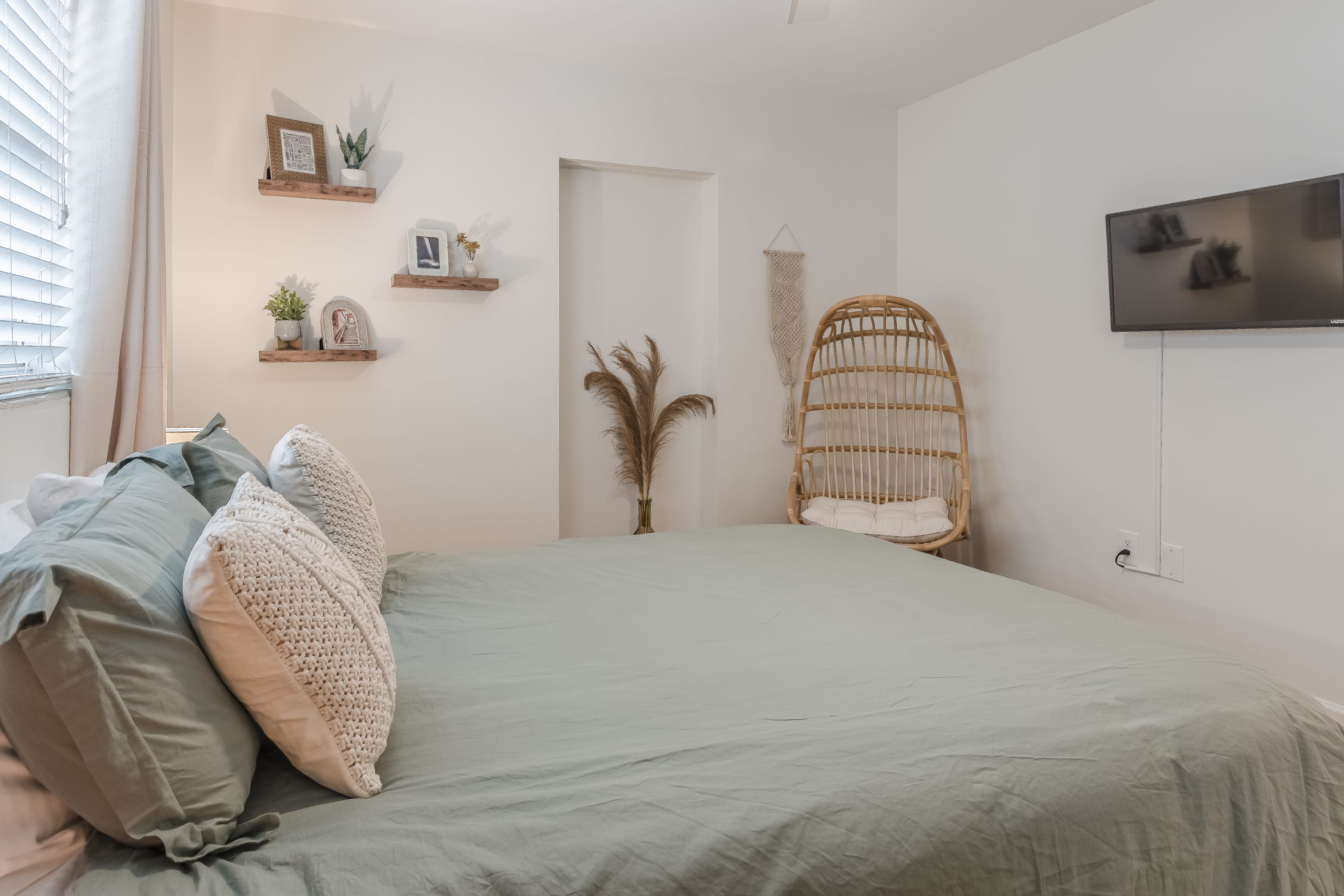 Close-up of the bed w/ textured pillows and inviting linens