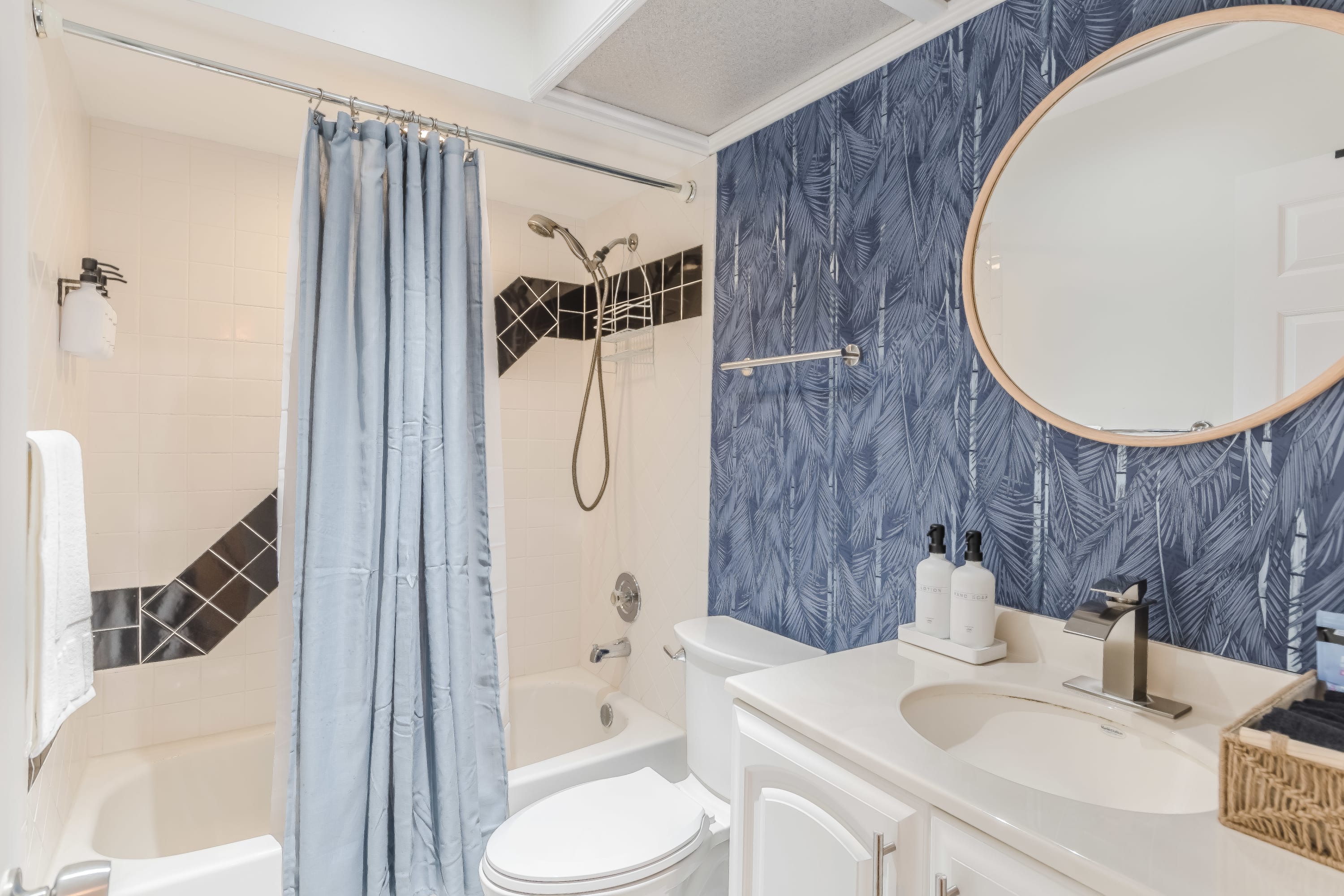 Bathroom featuring patterned tile and a fresh, airy feel