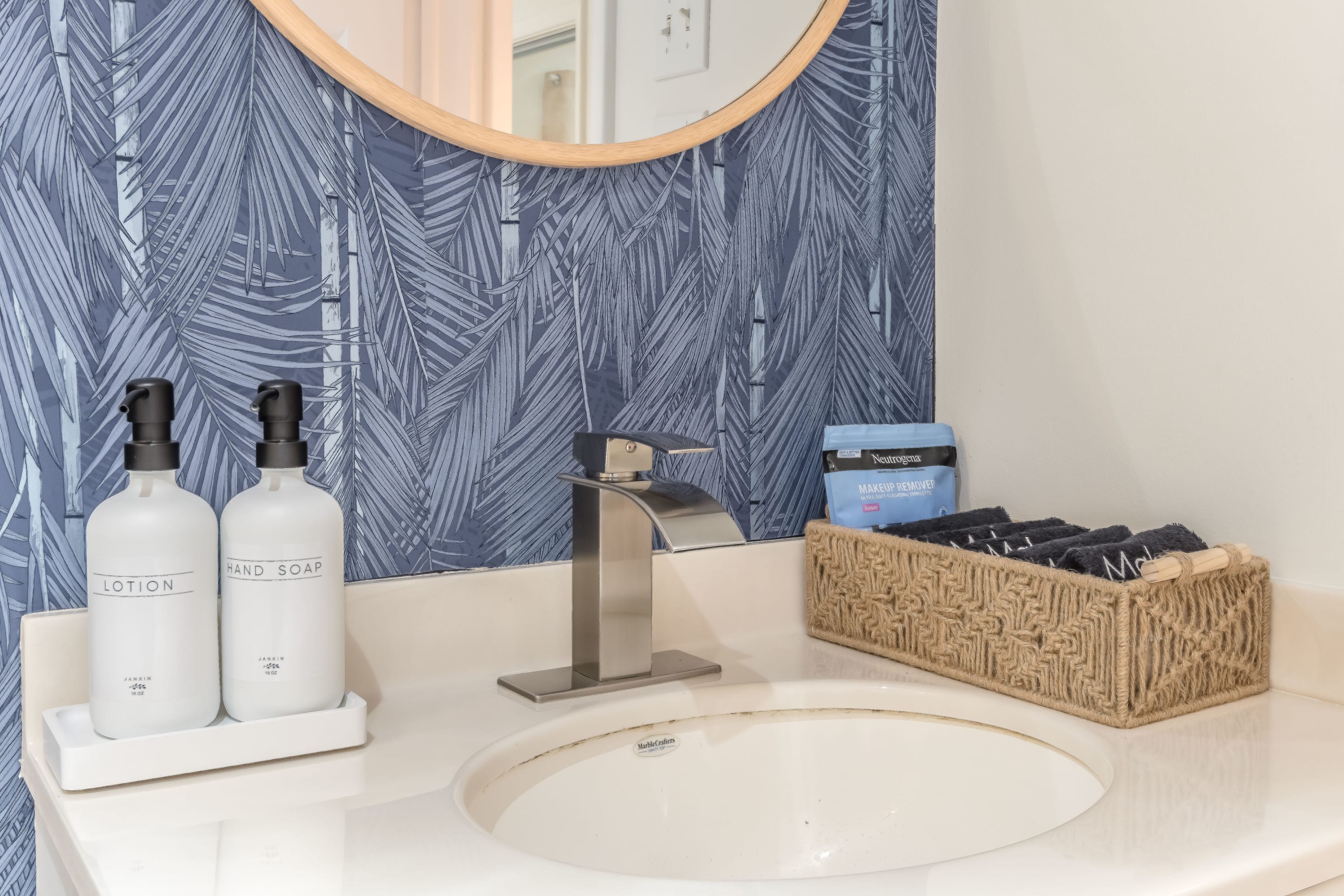 Vanity area w/ mirror and neatly arranged essentials