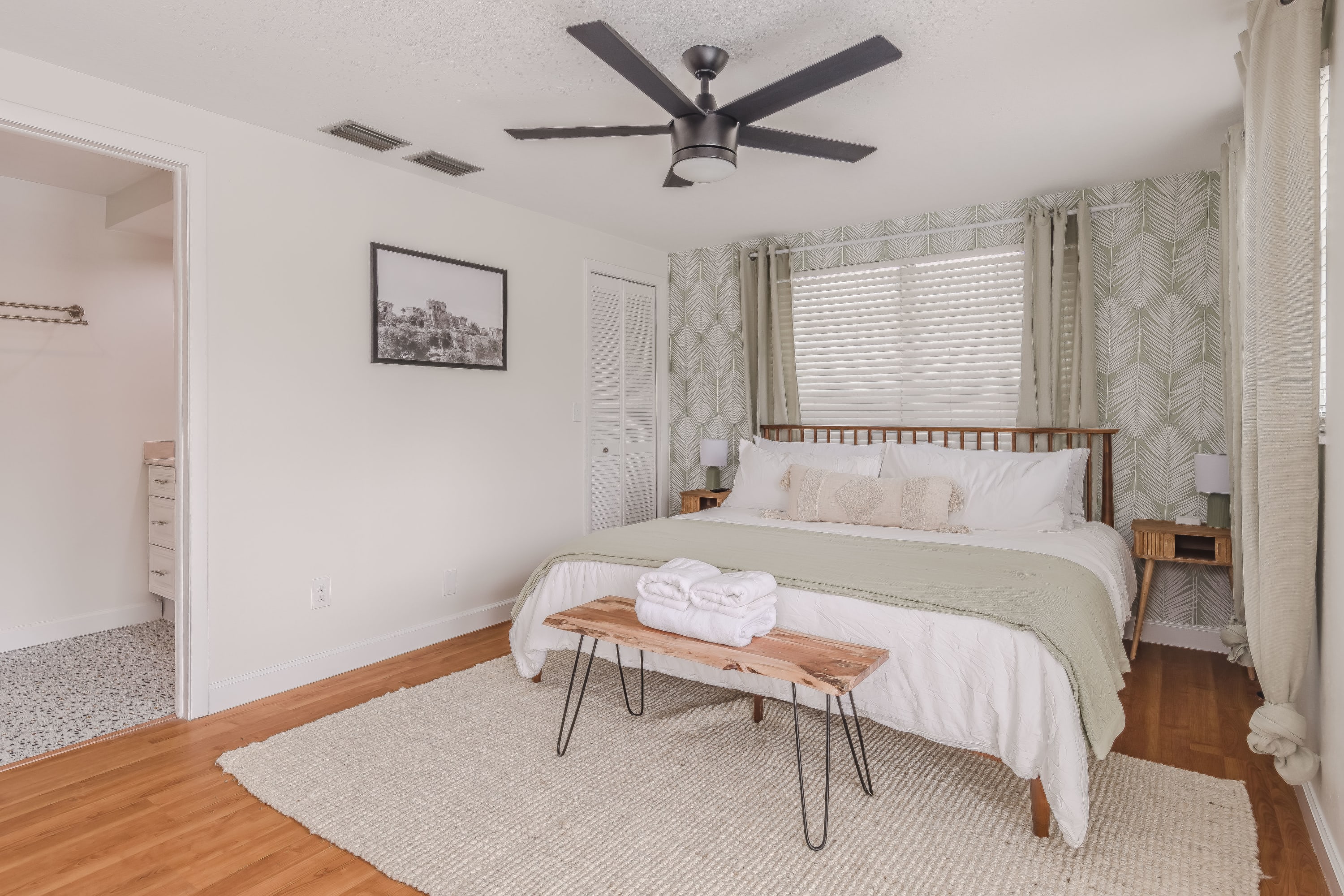 Cozy bedroom w/ ceiling fan and clean, calming decor