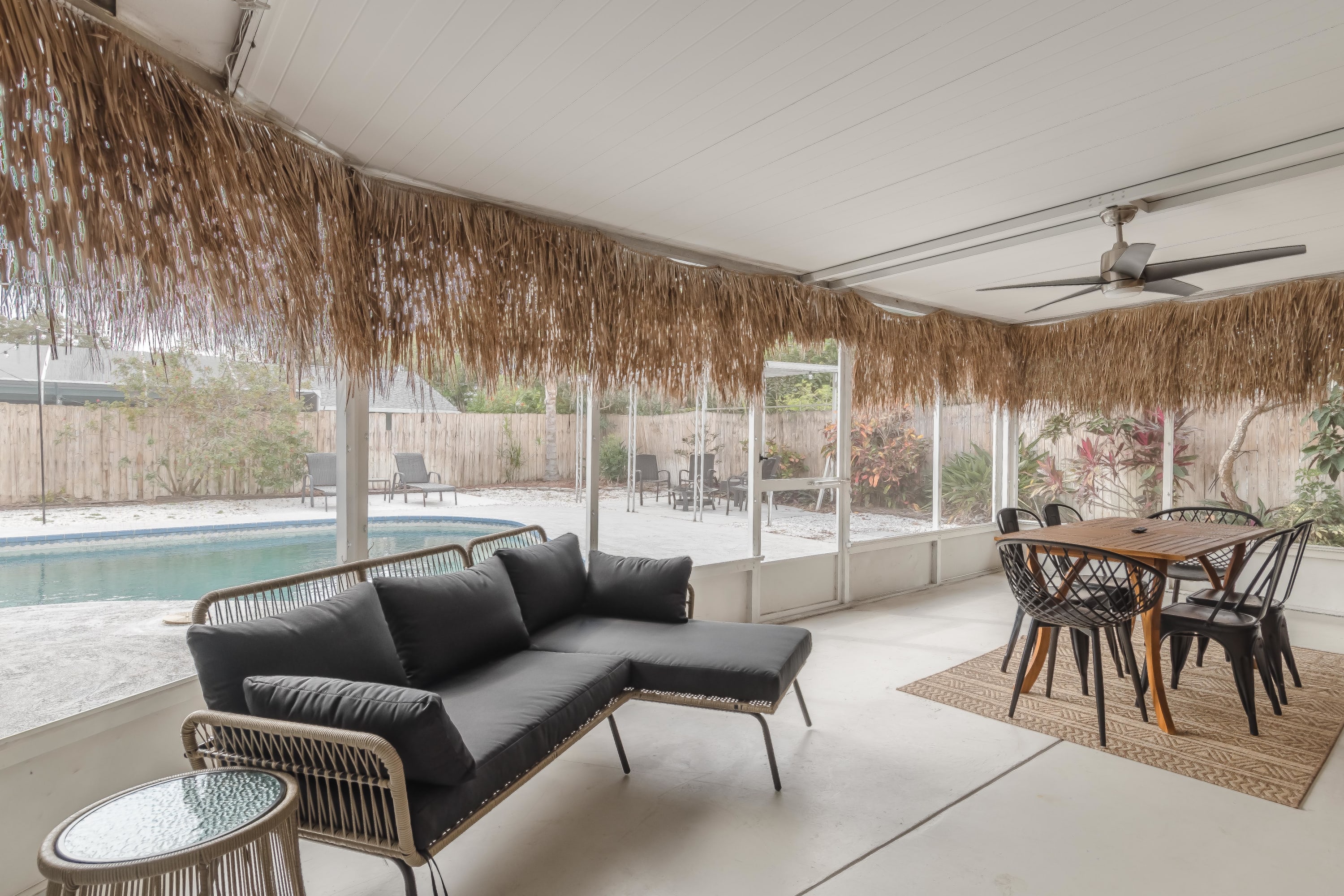Screened porch lounge w/ cushioned seating and peaceful views
