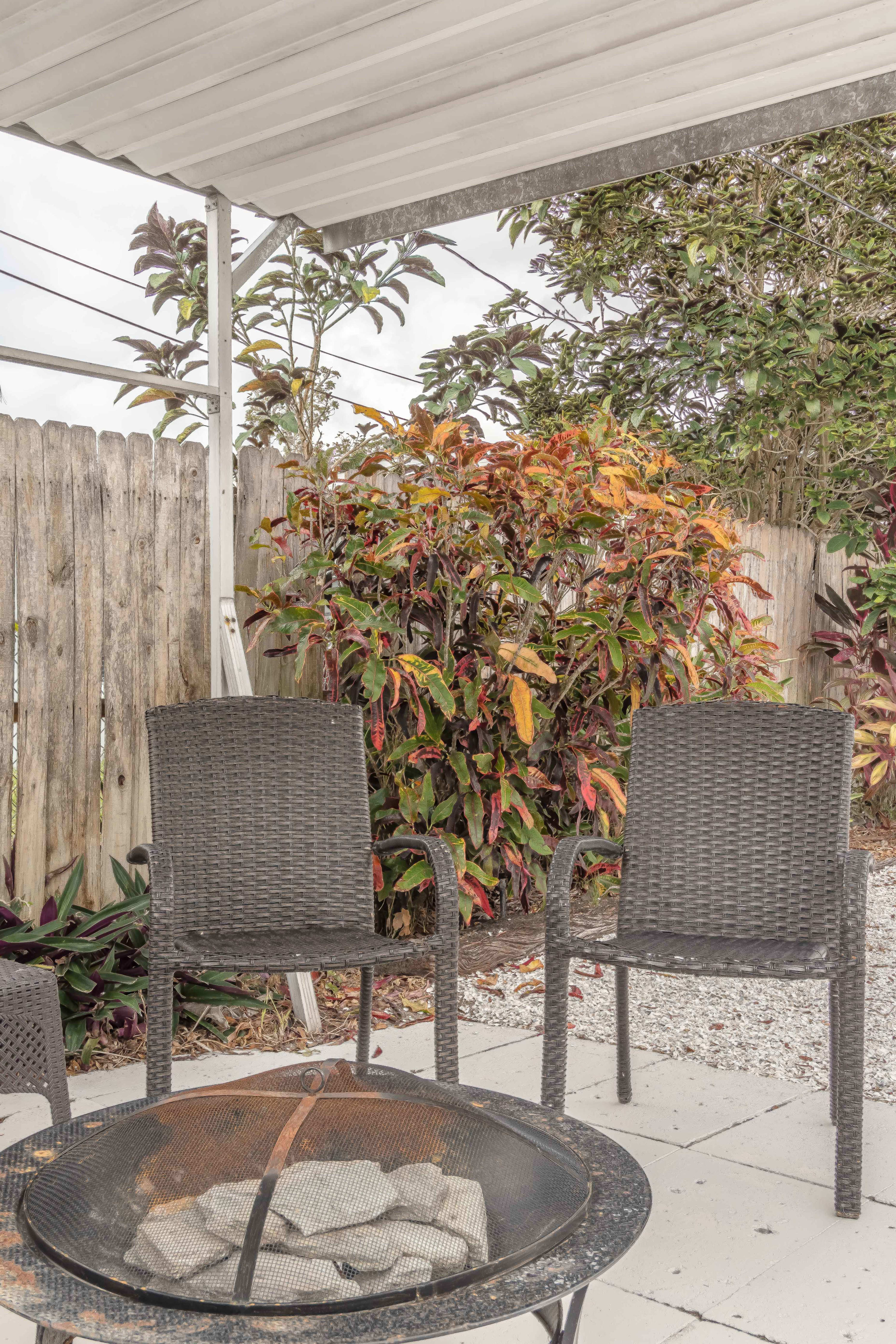 Side yard seating spot w/ simple table and chairs