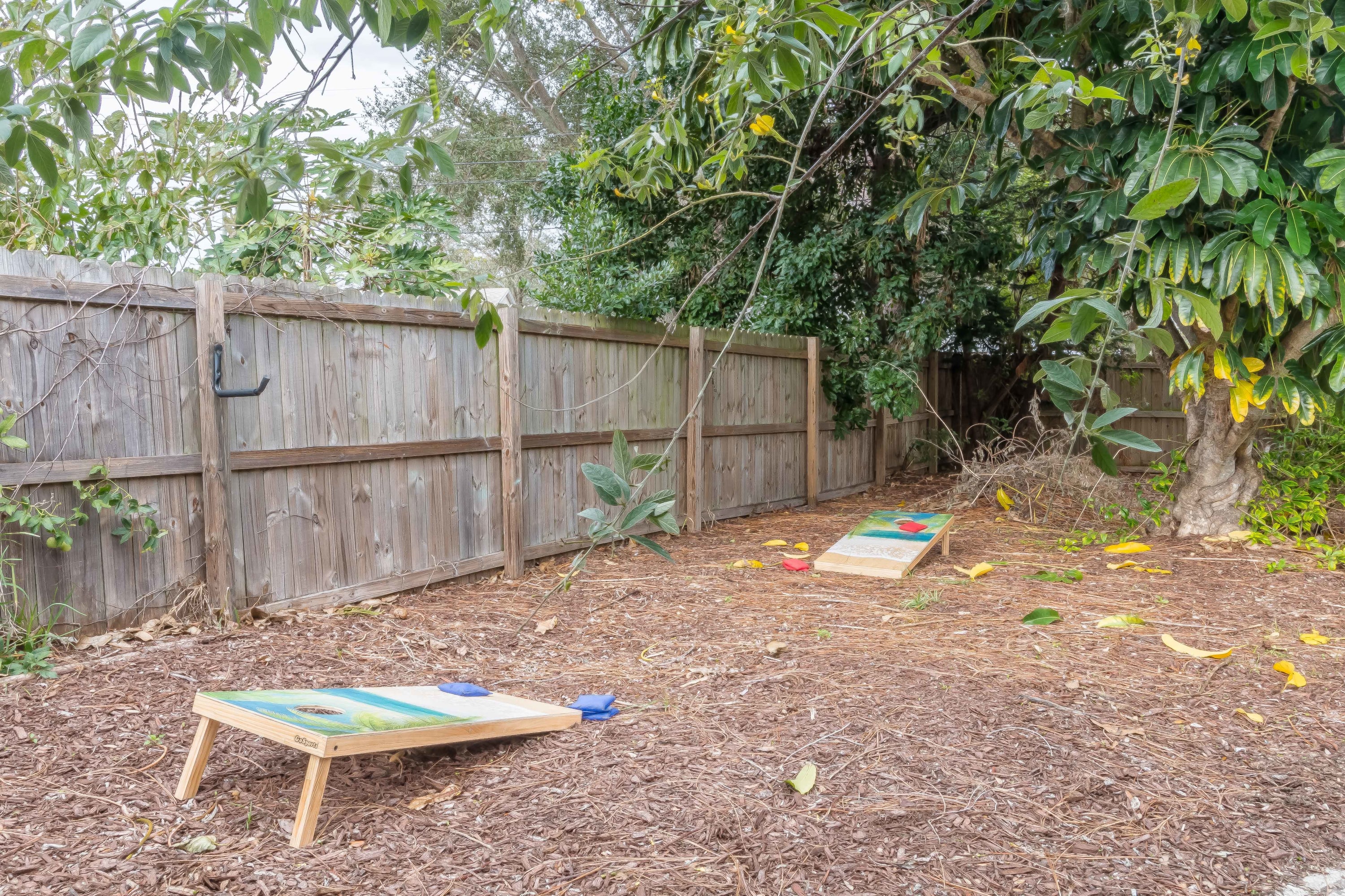 Open backyard space bordered by trees, offering a quiet, natural setting.