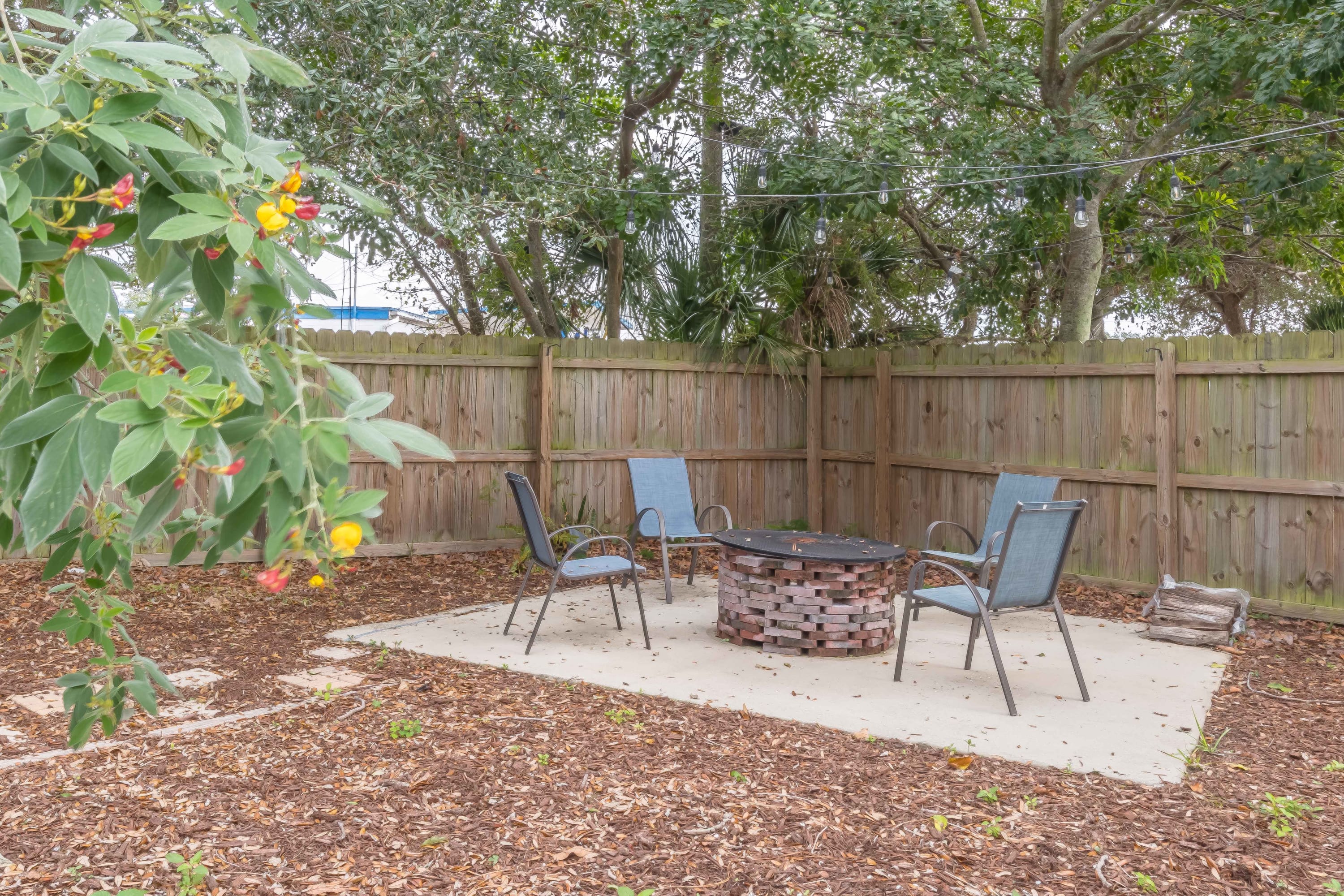Shaded yard w/ hammock chair, inviting you to slow down and relax outdoors.