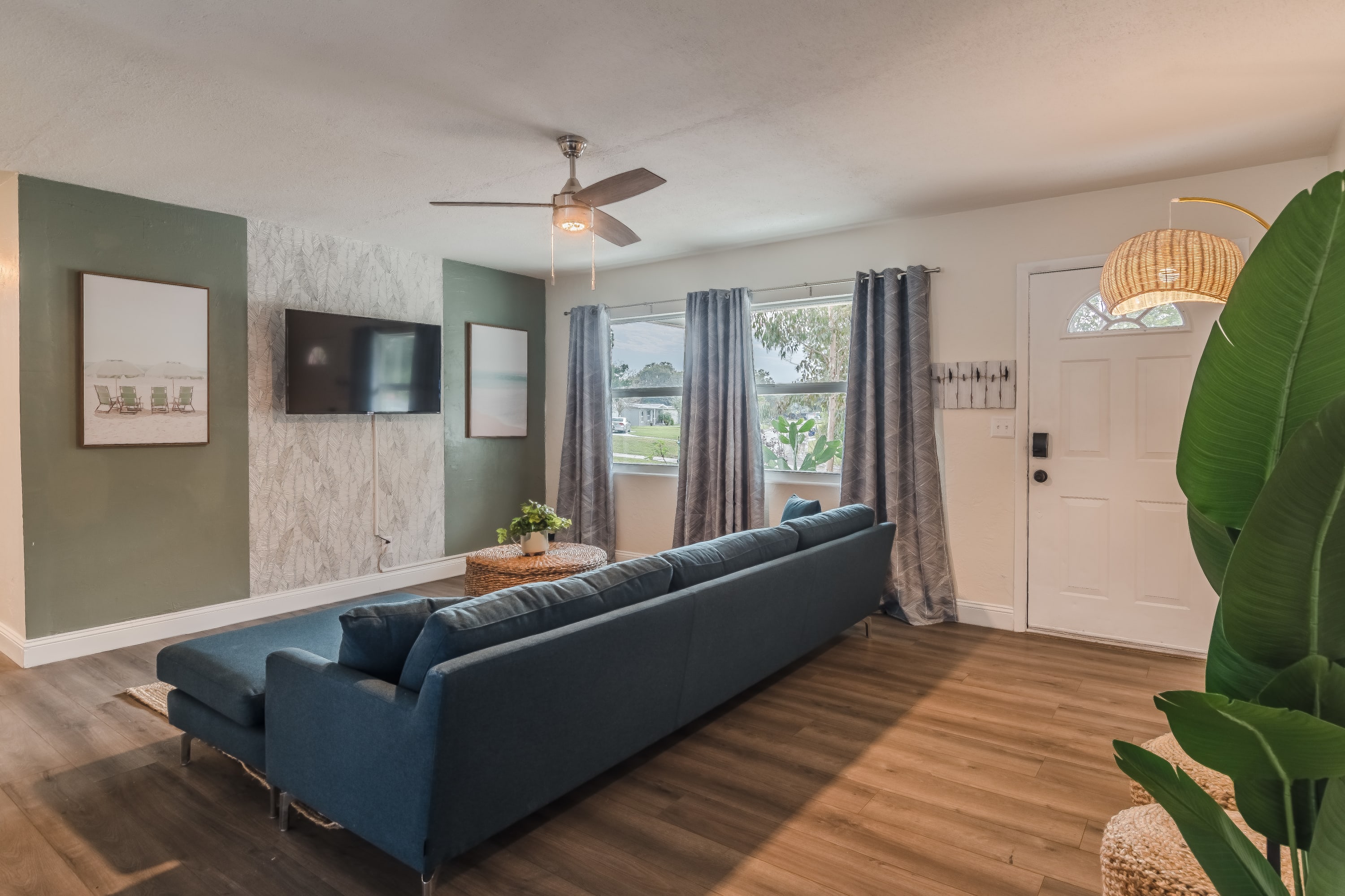 Living area w/ plush sofa and open layout, ideal for gathering and relaxing.