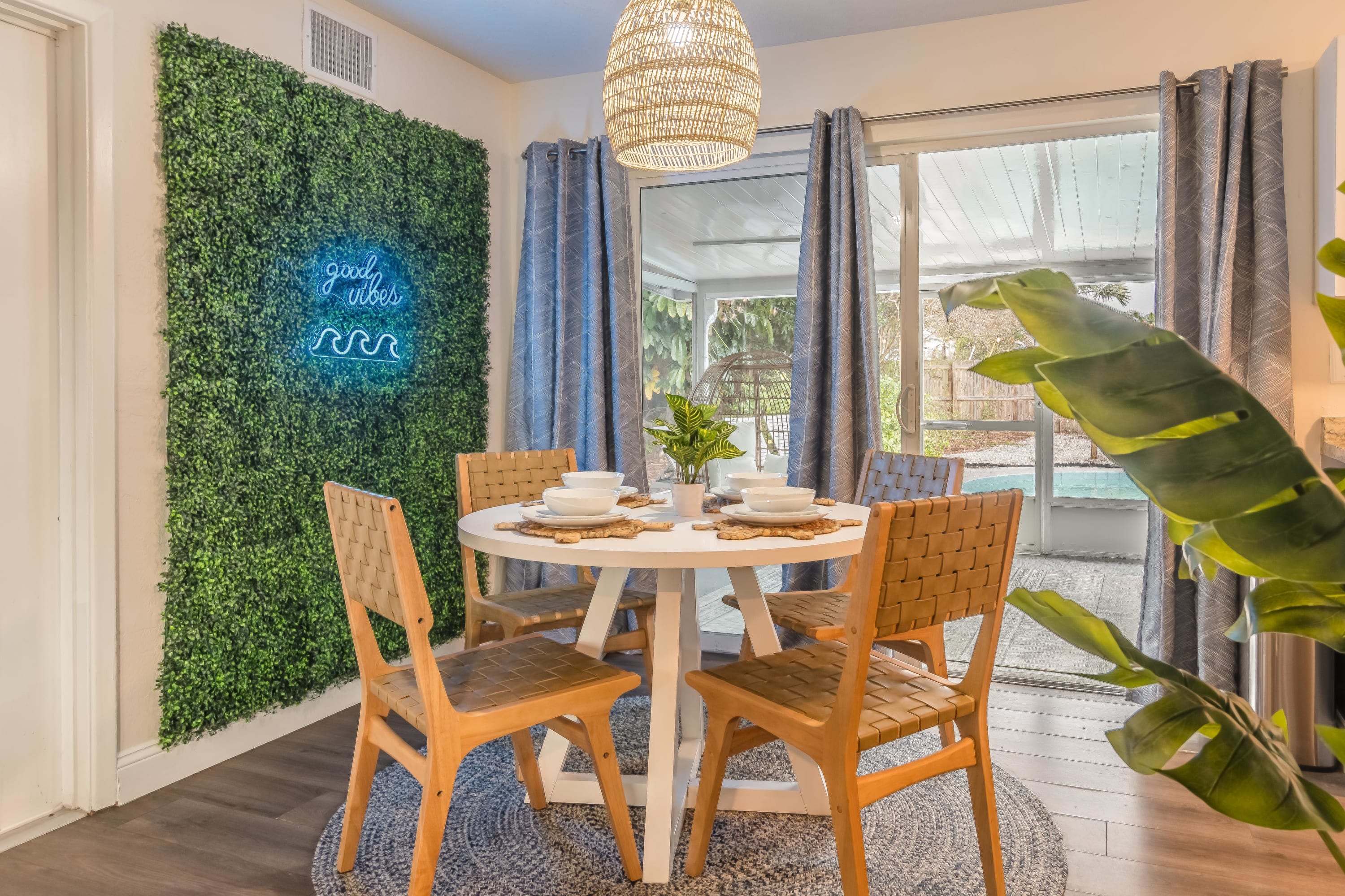 Sun-filled dining nook set beside greenery, ideal for easy meals and morning coffee.