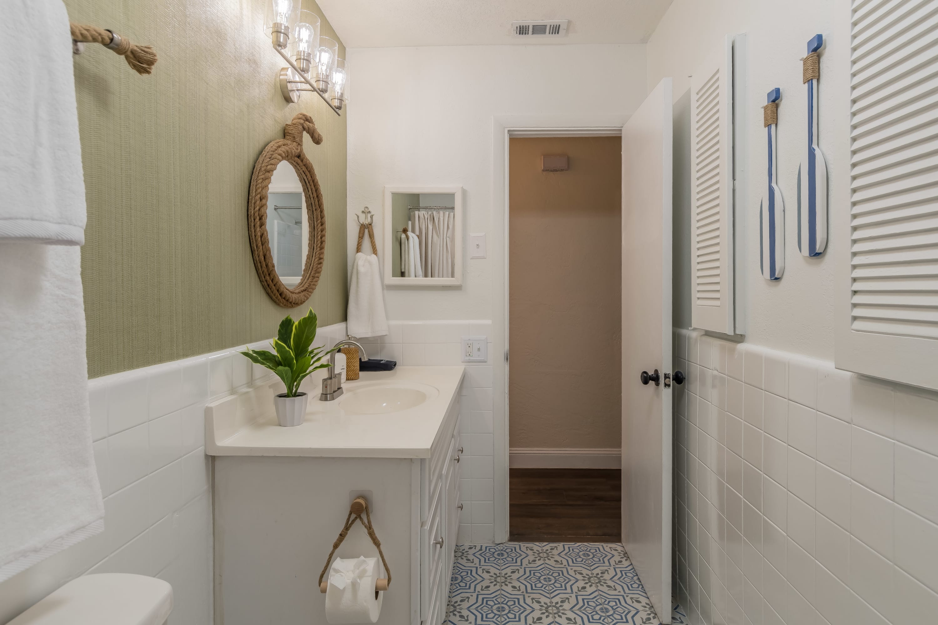 Bright bathroom w/ walk-in shower and crisp white finishes.