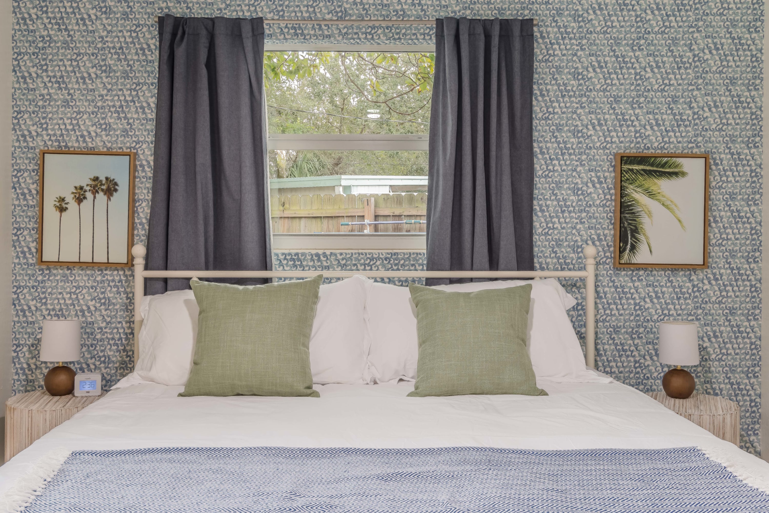Sunlit bedroom w/ plush pillows and a calm, inviting feel.