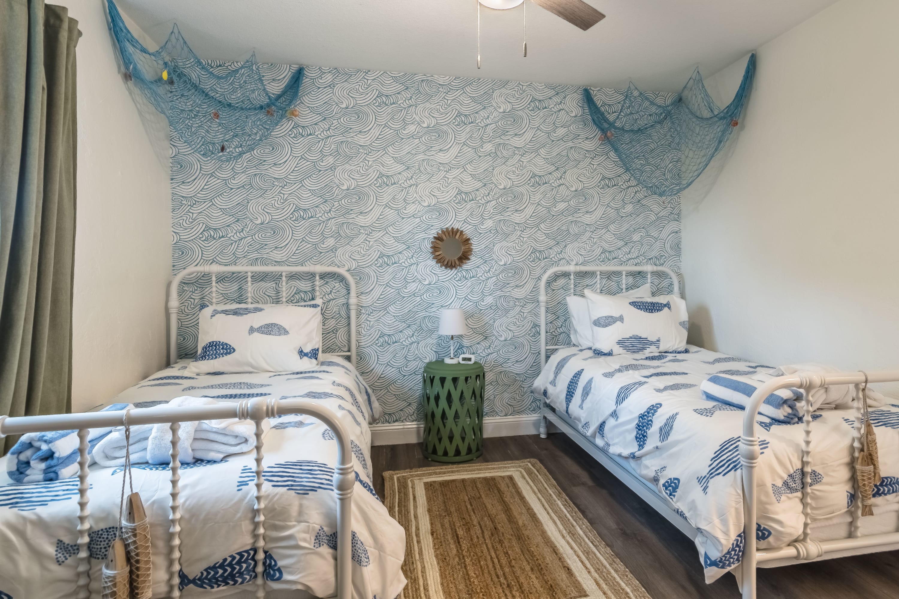 Cozy twin beds w/ soft linens and playful coastal touches for a restful night.