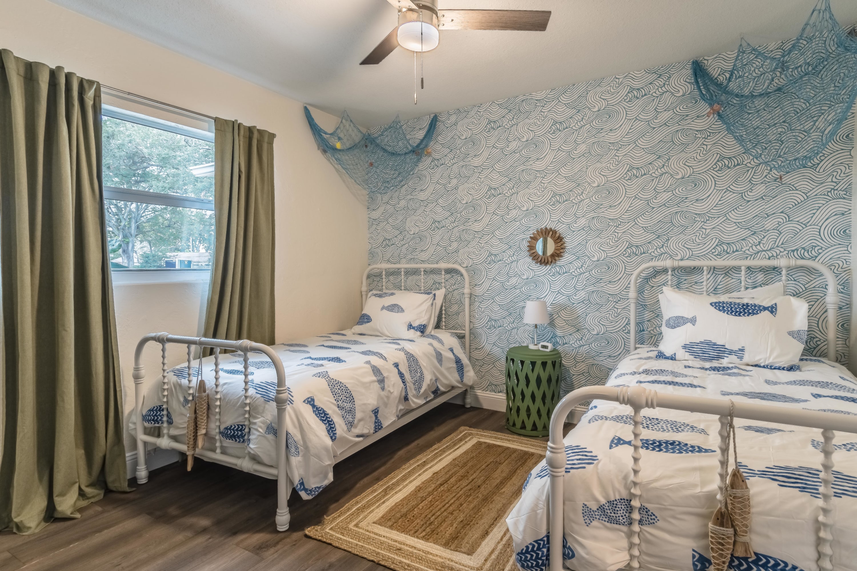 Twin bedroom w/ cheerful styling and a comfortable, relaxed setup.