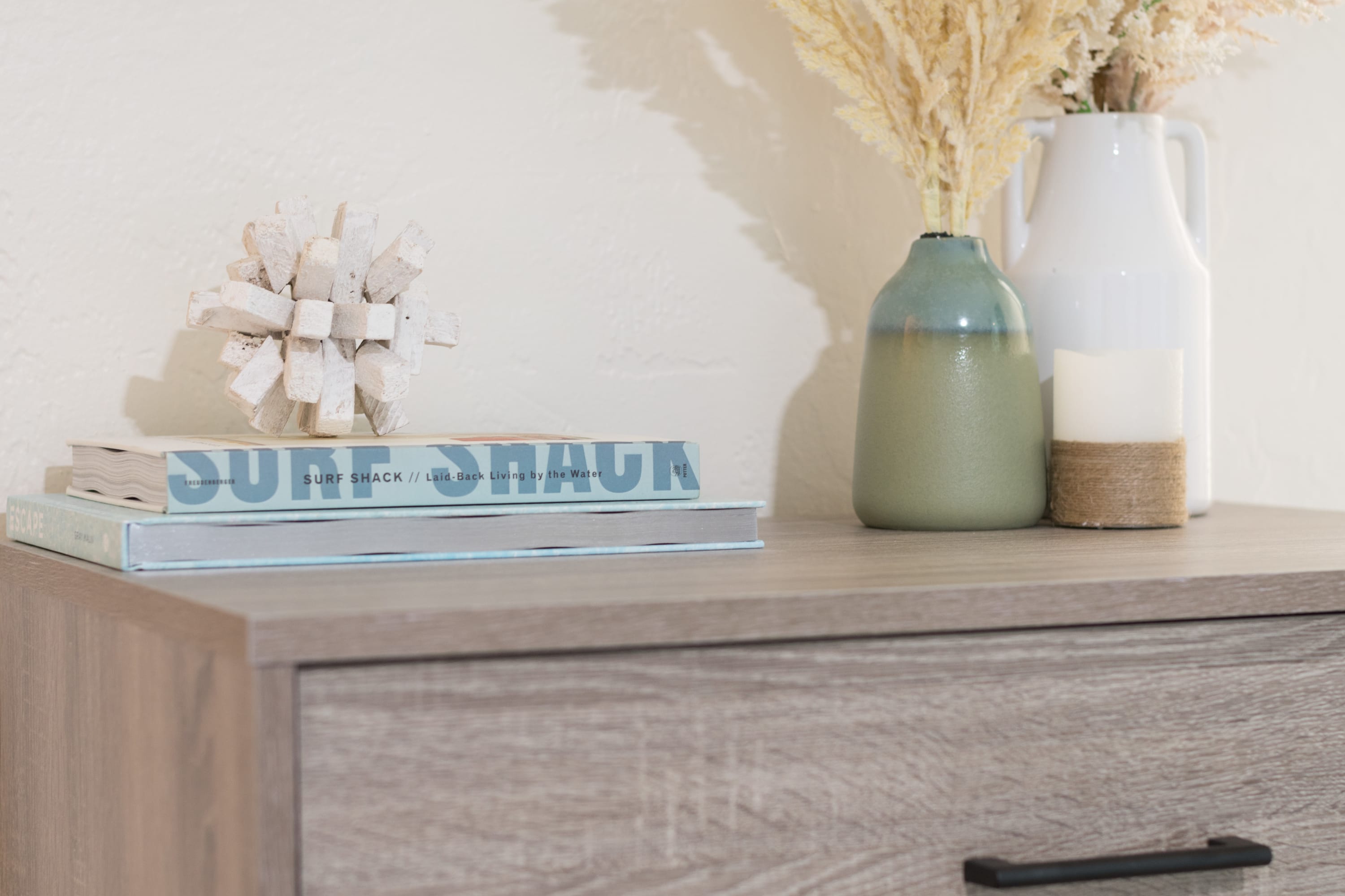 Styled dresser top w/ coastal accents adding charm to the space.