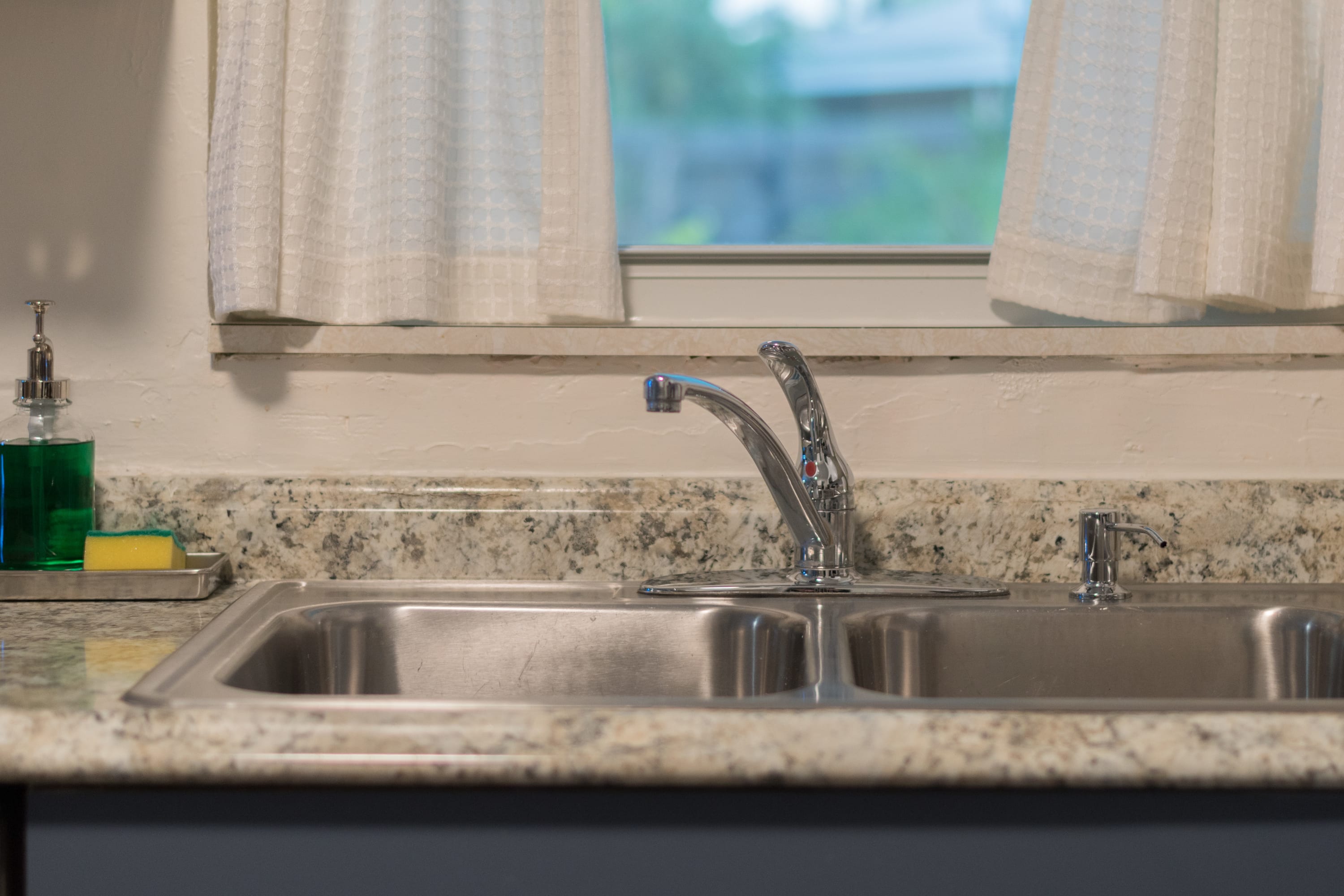 Clean bathroom vanity w/ bright lighting and simple, fresh finishes.