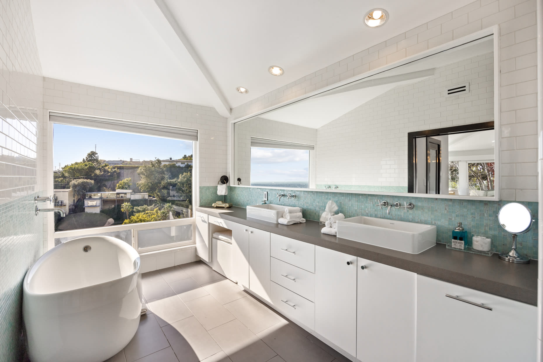 Enjoy luxury in our master bathroom, featuring a deep Bisazza tiled bathtub, double-sided showers, freestanding soaking tub, custom cabinetry, and premium toiletries.