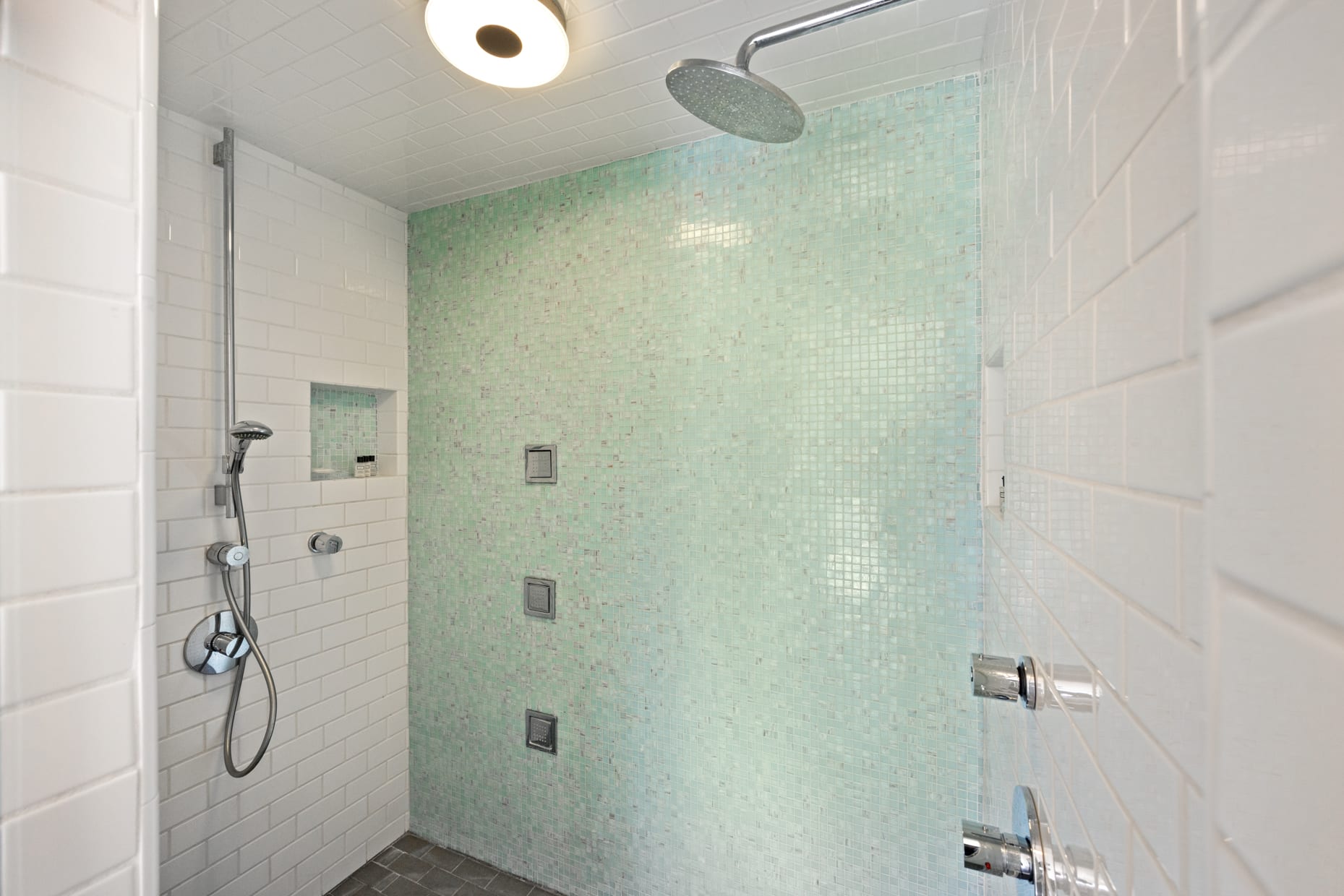 Refresh in our modern, stylish showers with dual Hansgrohe fixtures and premium Kohler Water Tile body sprays.