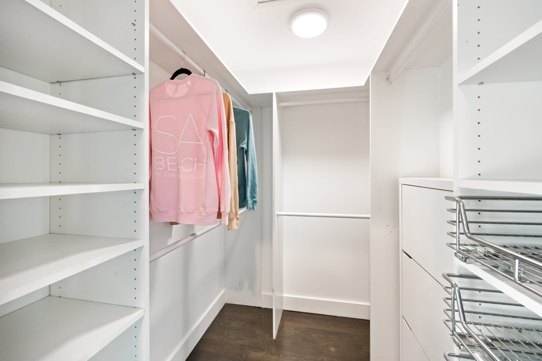 Step into luxury with our expansive walk-in closet, featuring ample storage space.