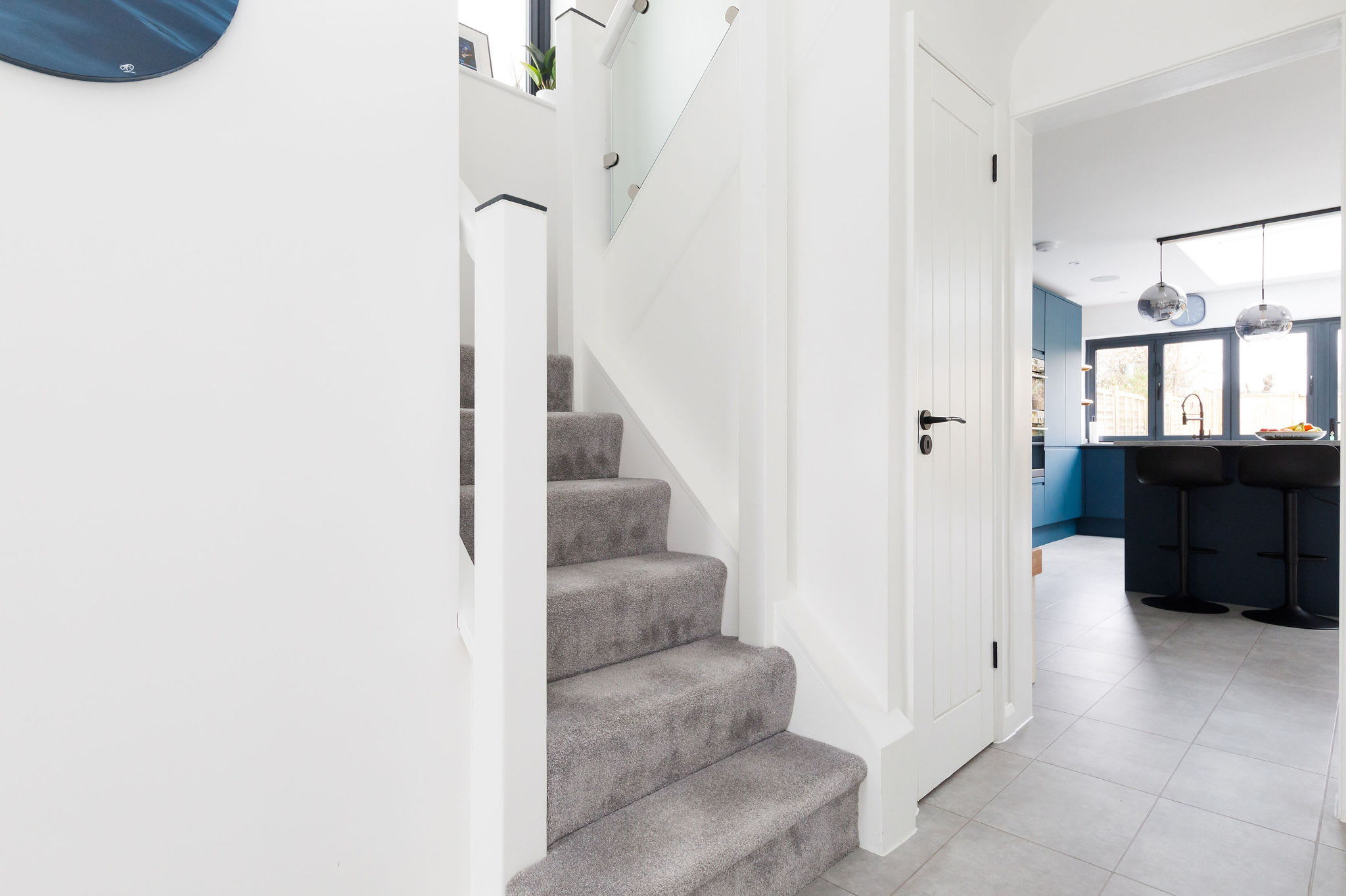 The stairs are located in the bright, airy hallway.