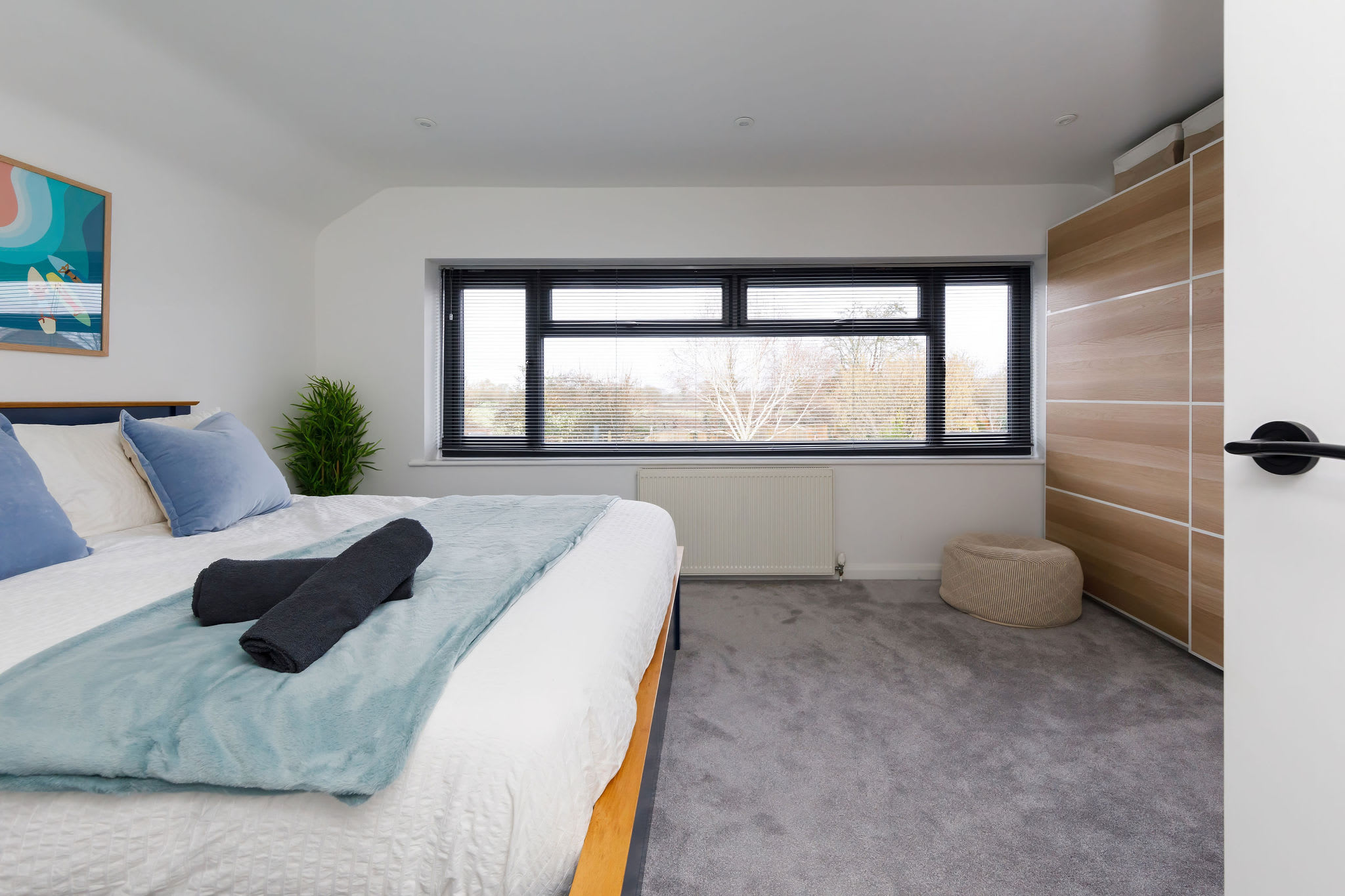 The master bedroom has a king size bed and large window to allow natural light to flood in.