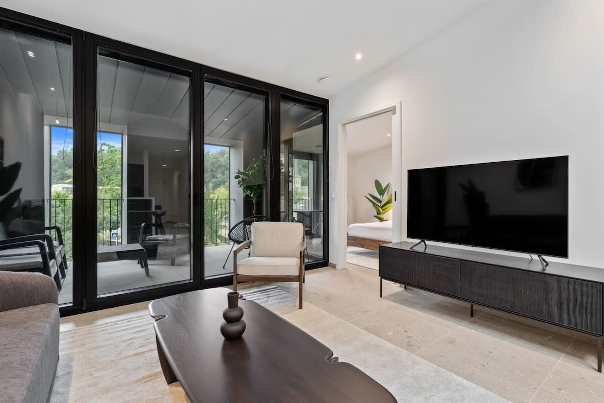 Relax in a chic living space that opens up to sunlit views.