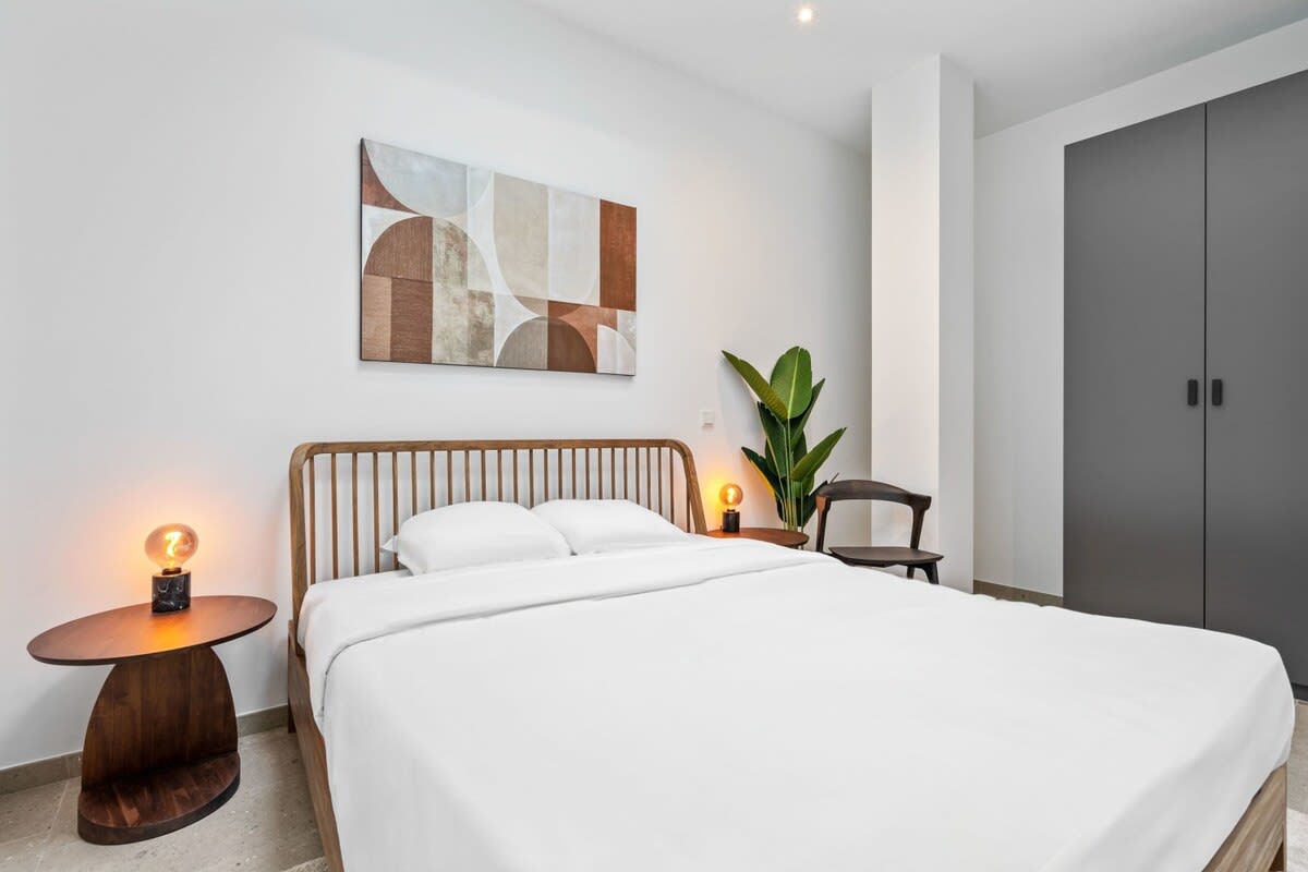 Sleek design and comfort meet in this peaceful bedroom oasis.