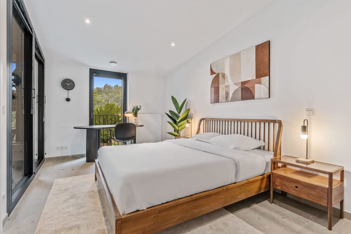 Wake up to serenity in our modern bedroom, complete with a view of nature's beauty.