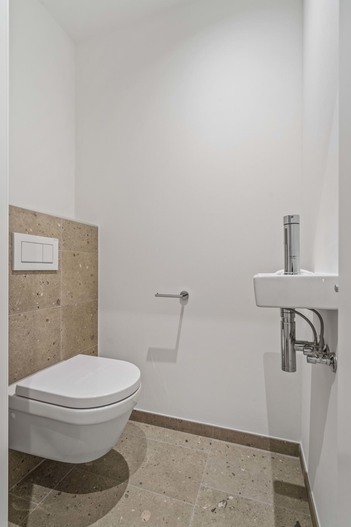 Sleek and modern half-bath for your convenience and comfort.