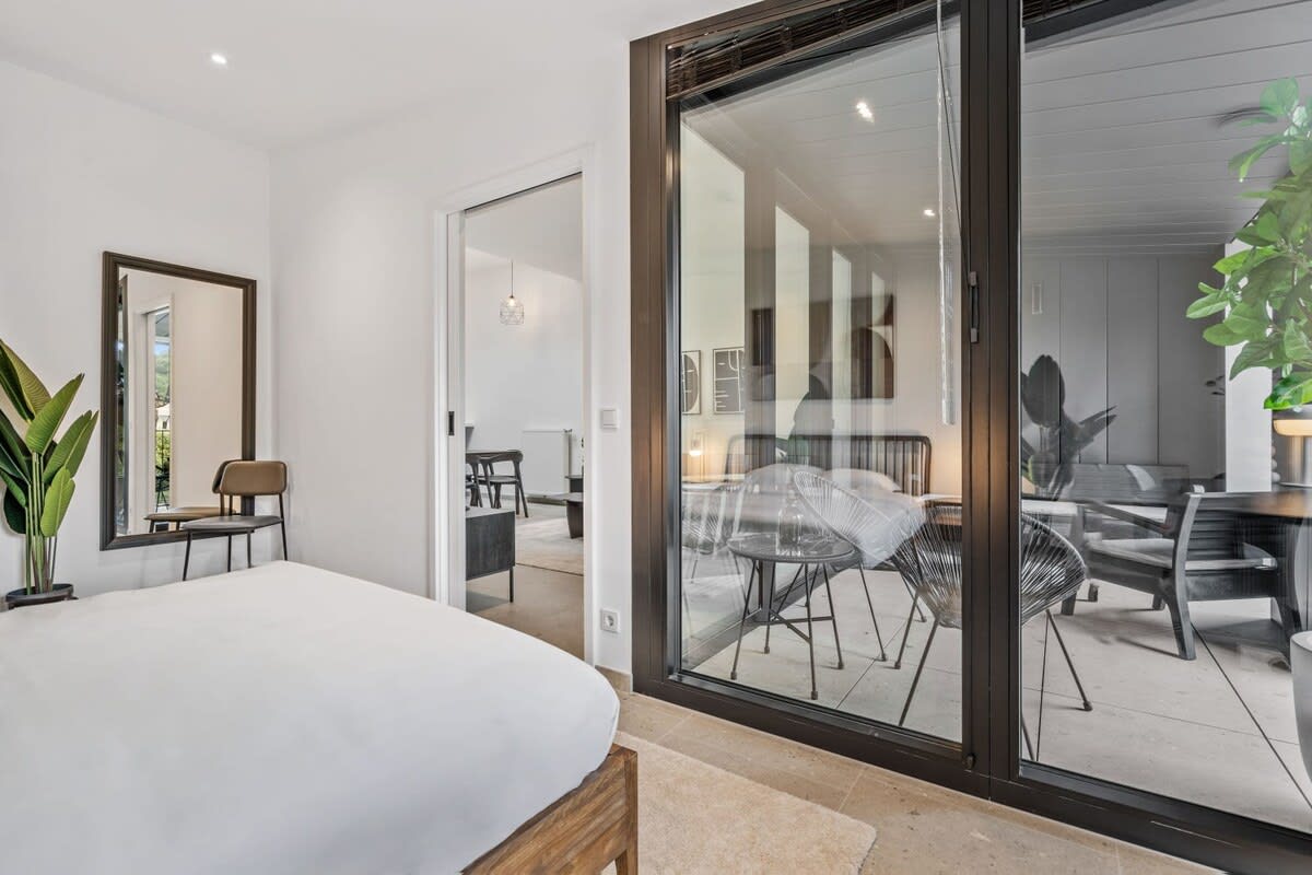 Bright, beautiful mornings await in this bedroom with a balcony view.