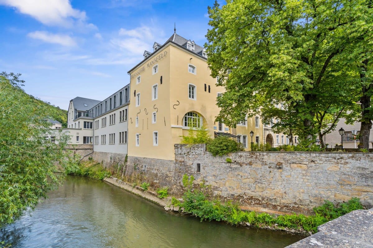 Elegant riverside living where historic walls whisper timeless tales.