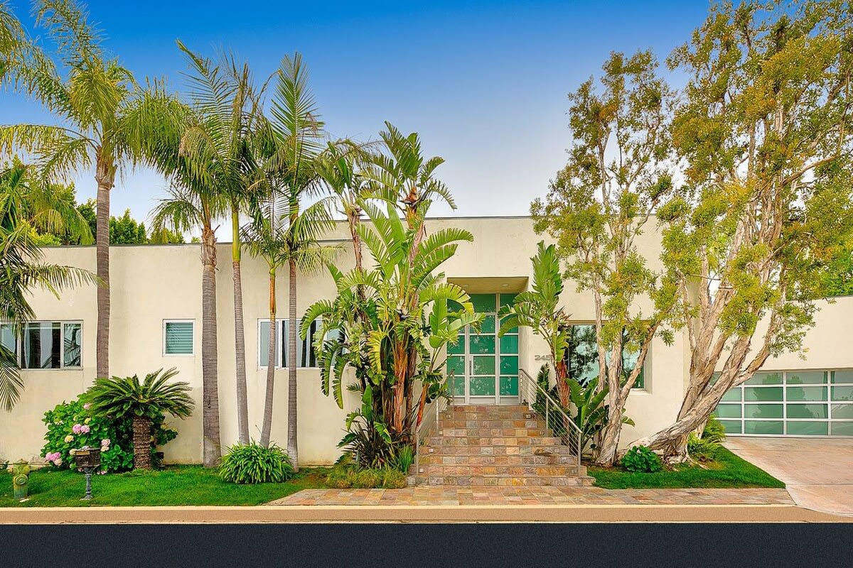 Step into the home entrance adorned with palm trees, welcoming you to your private oasis.