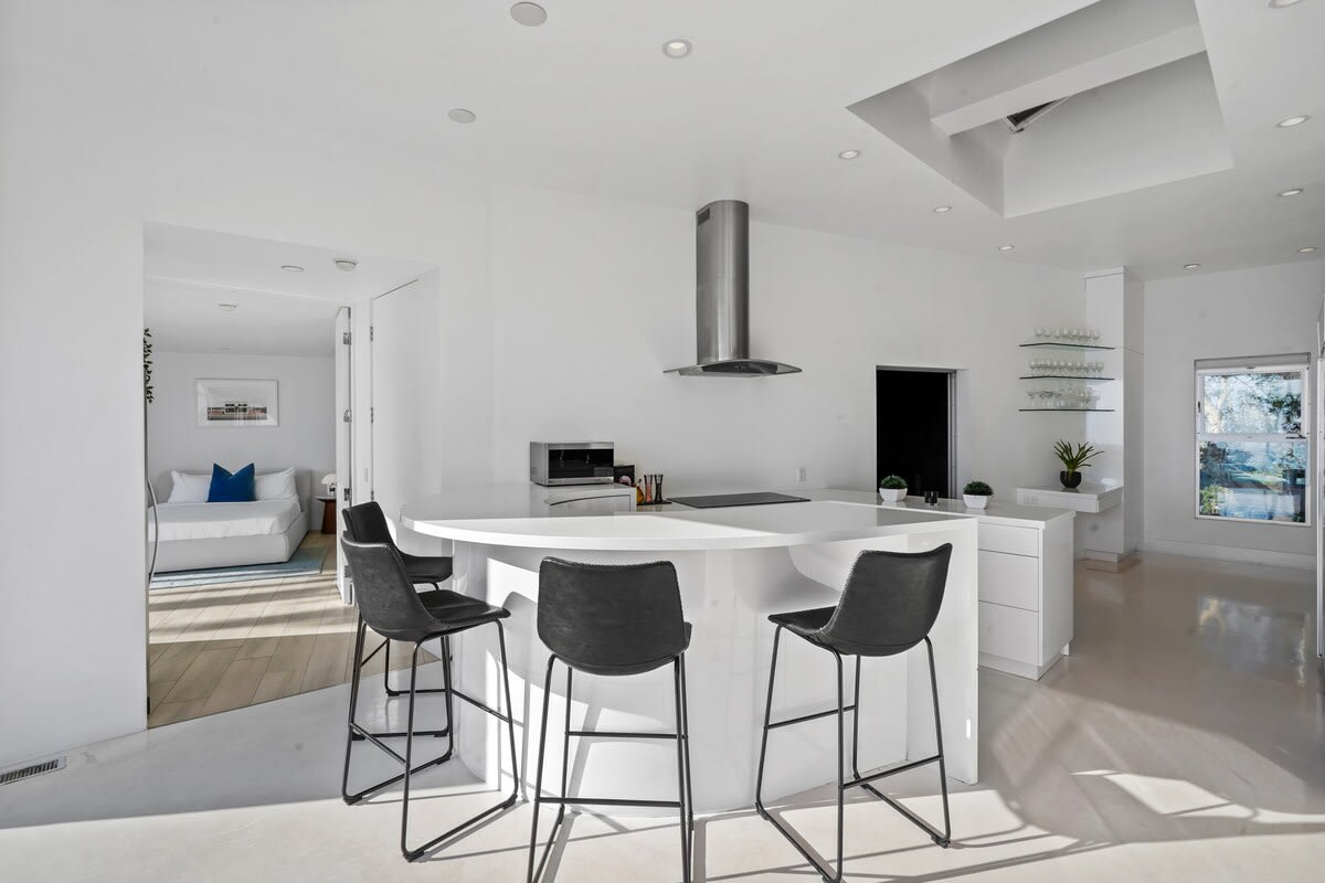 The kitchen's bar counter with four stools invites socializing and additional seating.