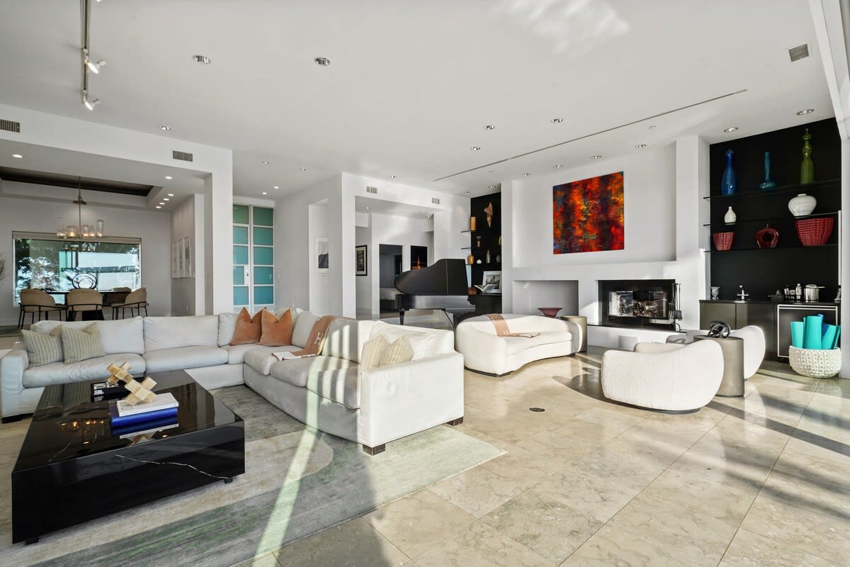The Living Area offers plentiful seating options bathed in natural sunlight, creating a warm and inviting space for relaxation.