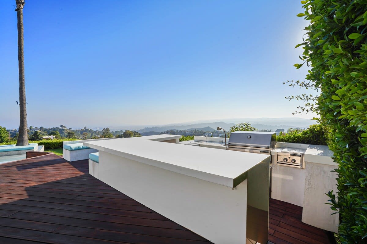 Entertain in style at the outdoor kitchen with a large counter, perfect for hosting memorable gatherings.