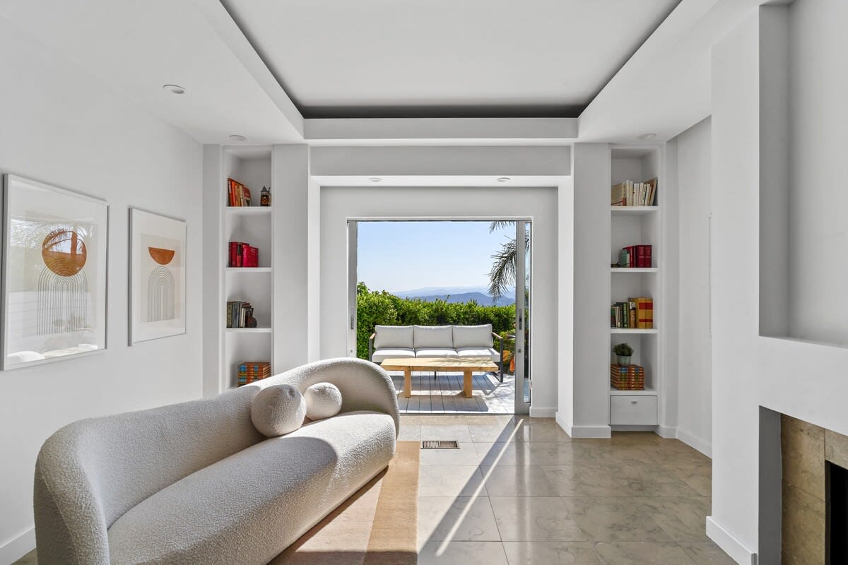 Primary bedroom features a cozy sitting area for moments of relaxation and comfort.
