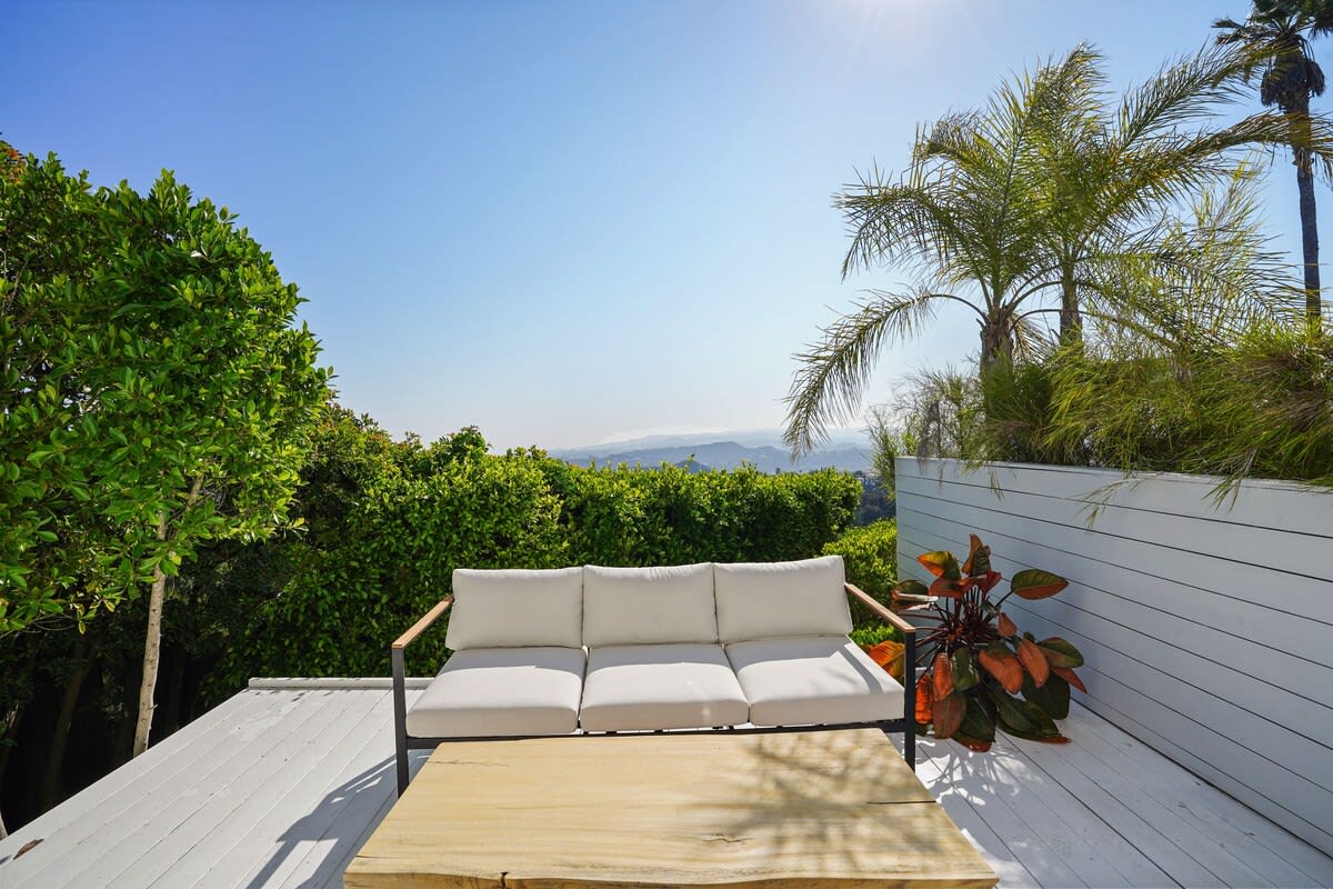 Step out onto the outside balcony directly from the primary bedroom, and soak in the beauty of the surrounding views.