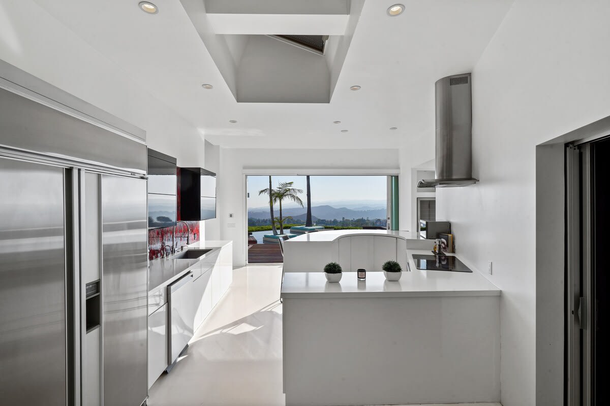 The kitchen seamlessly connects with the outdoors, allowing fresh air and natural light to fill the space.