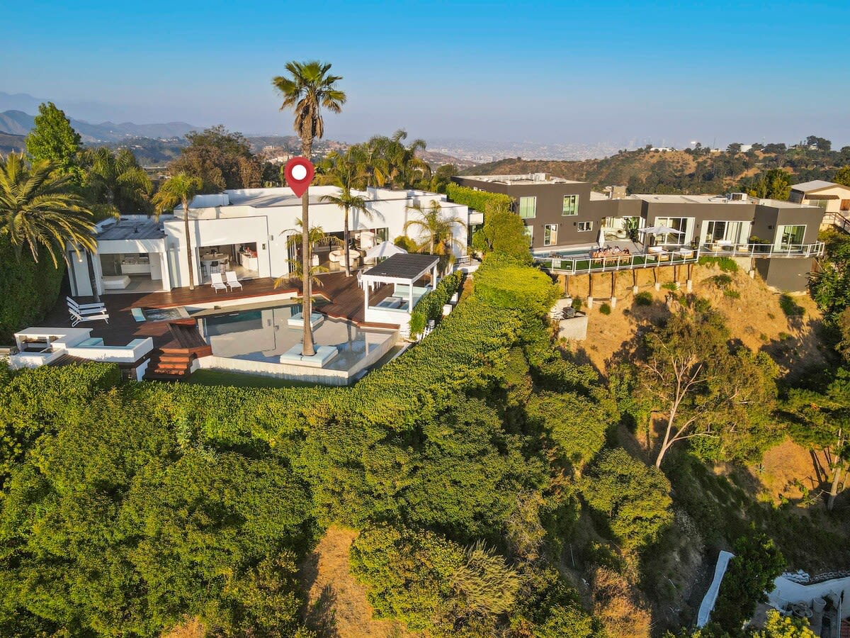 Enjoy a drone shot of the home surrounded by lush greenery, offering a picturesque escape in nature's embrace.