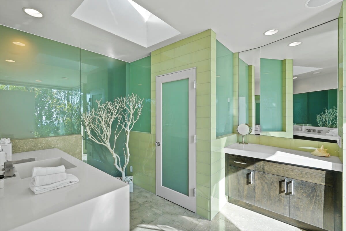 Experience the serene ambiance of the ensuite bathroom in the primary bedroom, with a skylight providing natural light.