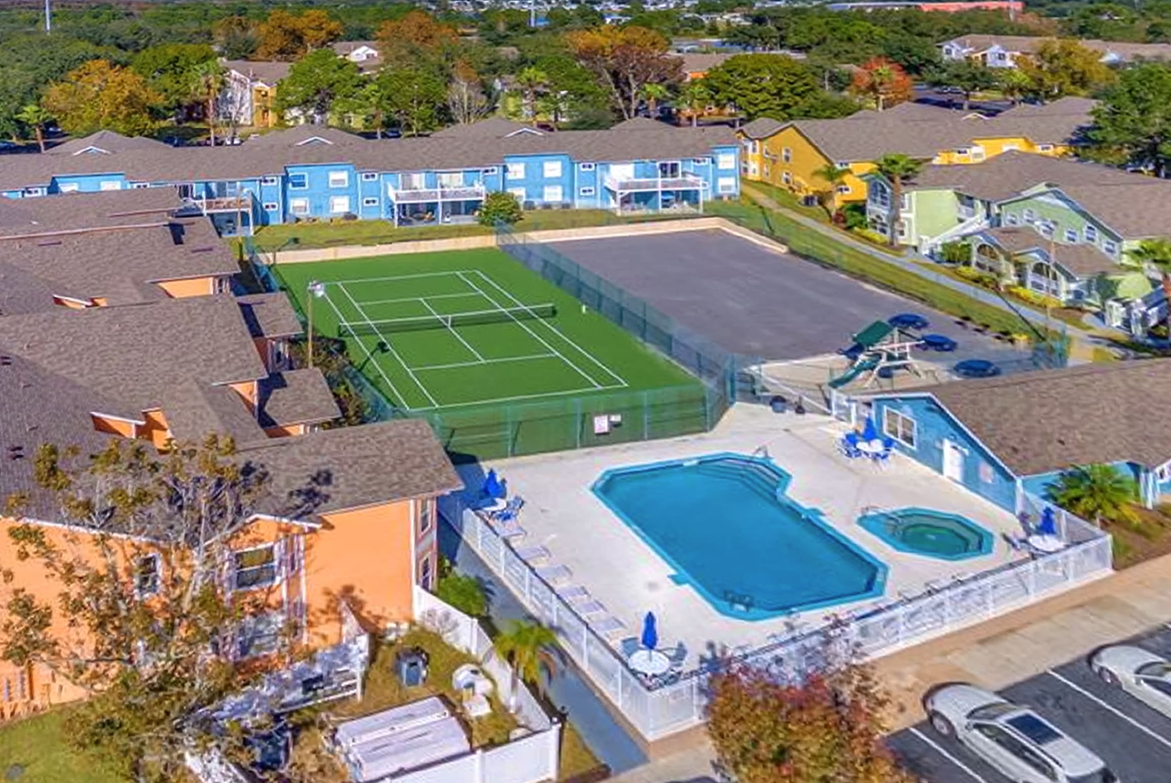 Stunning Aerial View Of The Community Pool, Tennis Courts, And Grounds