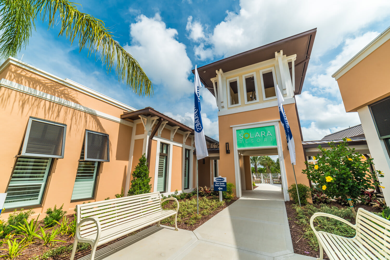 Entrance to solara resort with tropical landscaping and seating areas