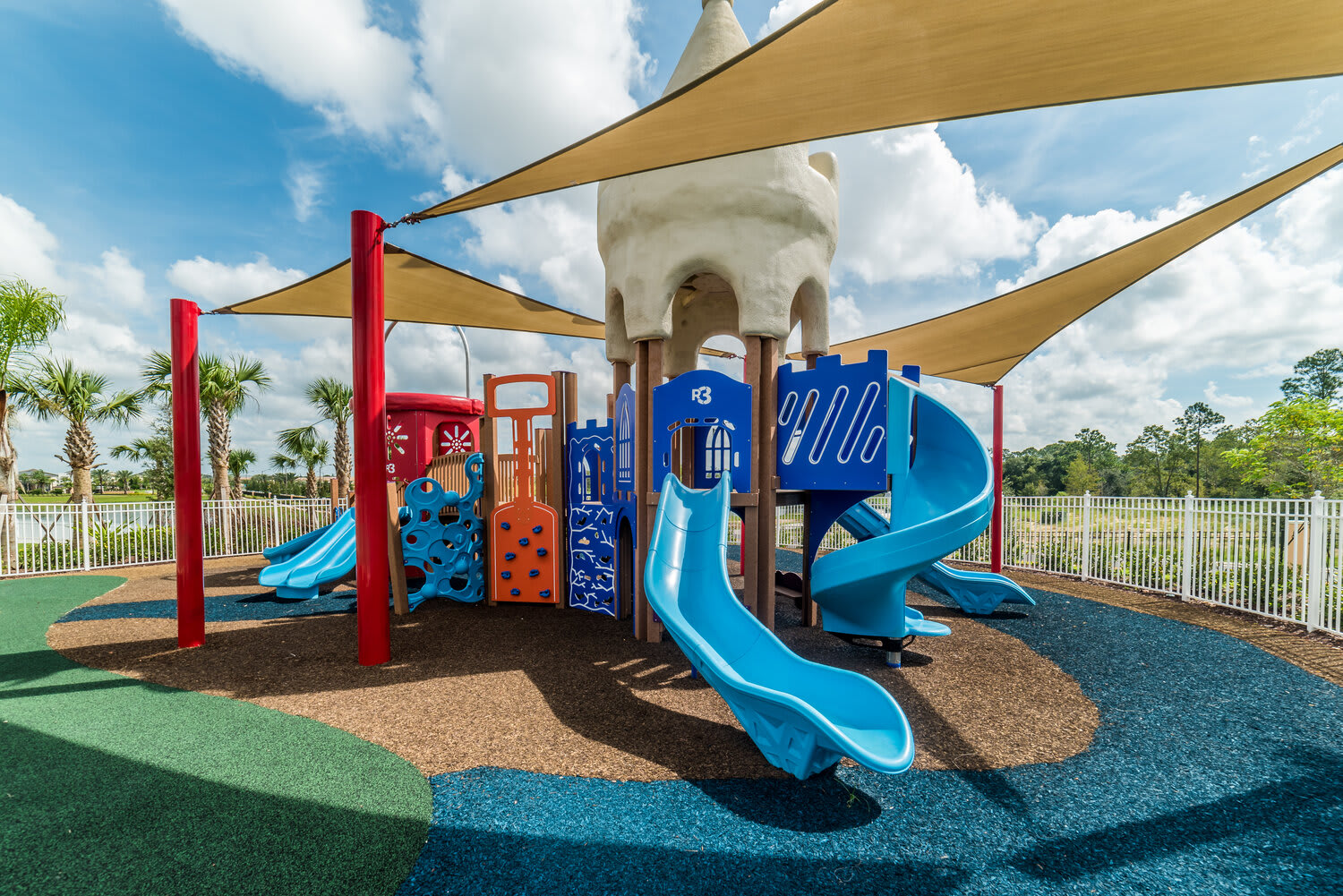 Outdoor playground with colorful slides and shade sails for family fun