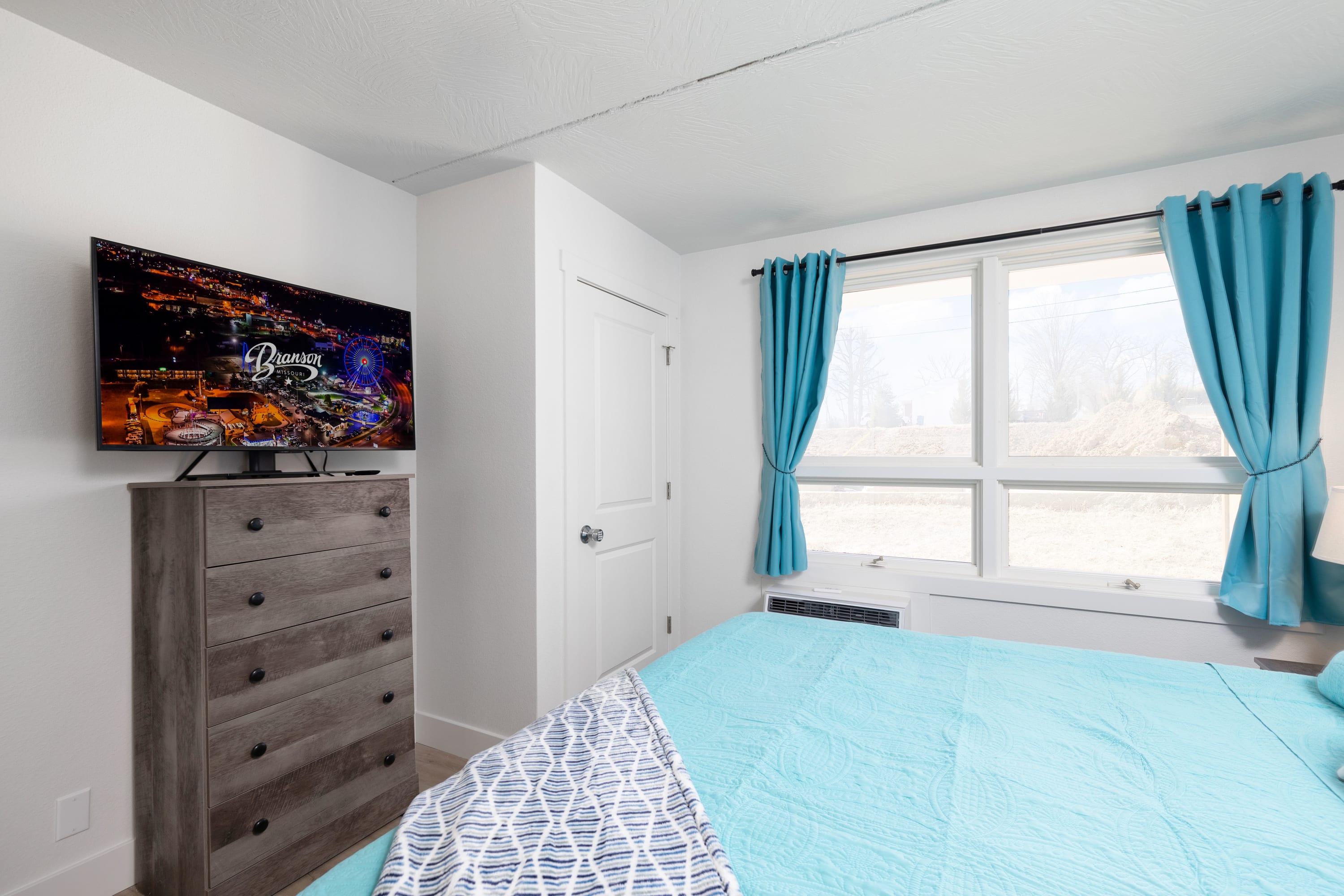King Suite offers a side chair and 45" Insignia FireTV.