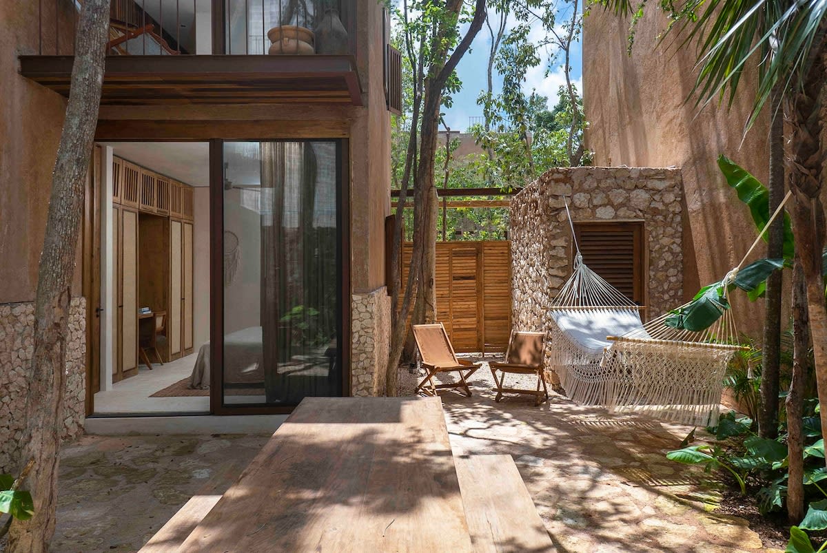 Private garden with outdoor dining table and hammock