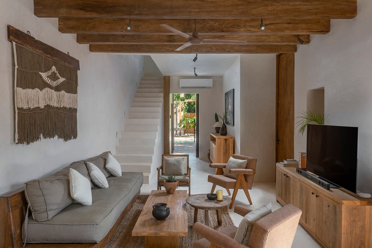 Fully furnished living room with TV, located on the ground floor.