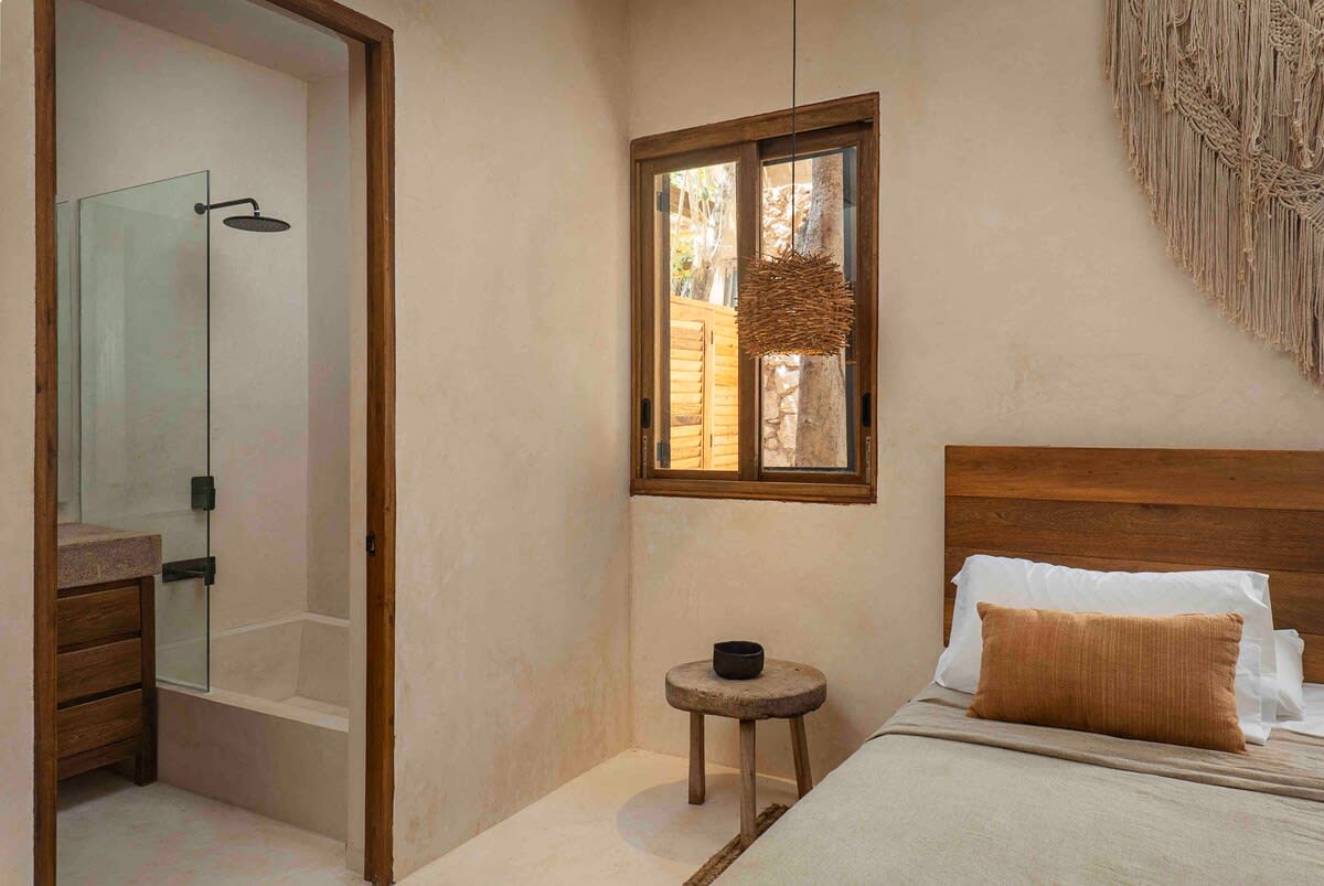 Main floor bedroom, with a bathtub featured in the ensuite bathroom