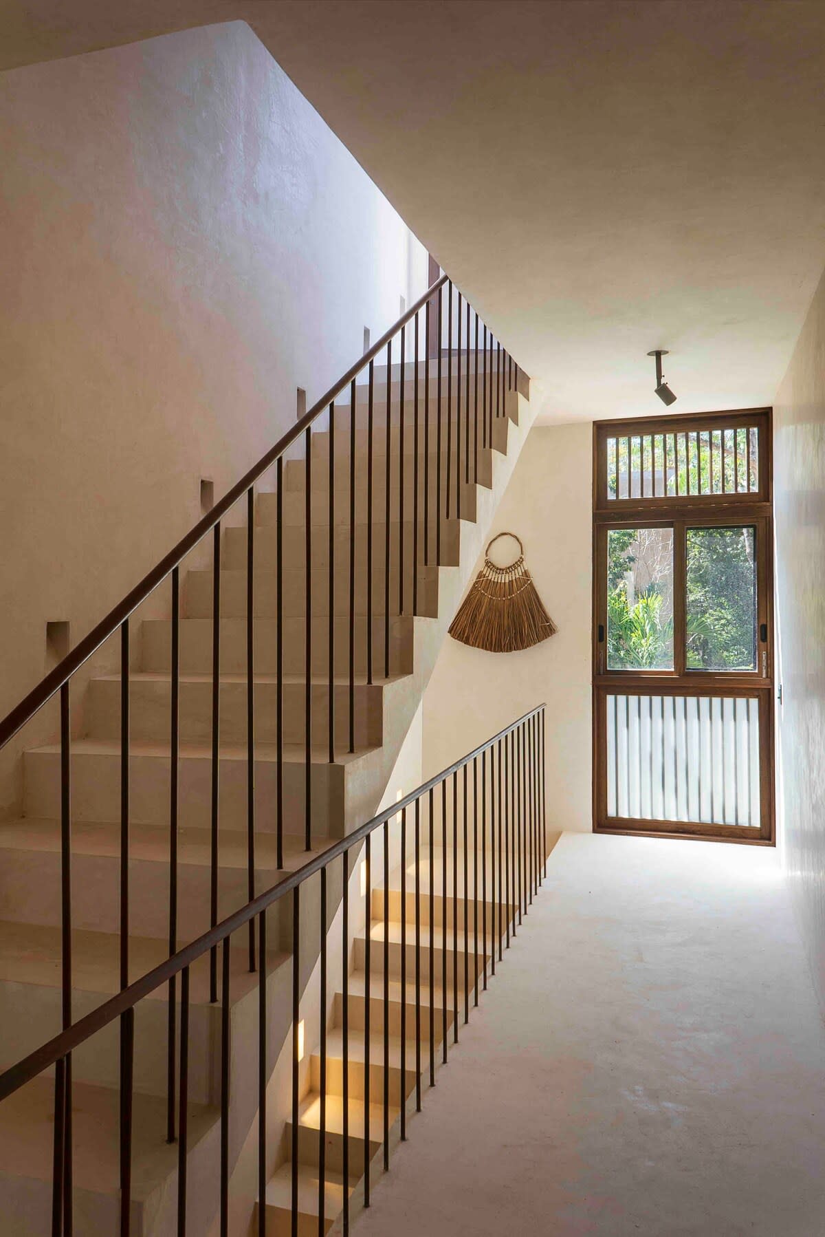 Second floor hosting bedrooms 2 and 3, with stairs leading to the rooftop oasis