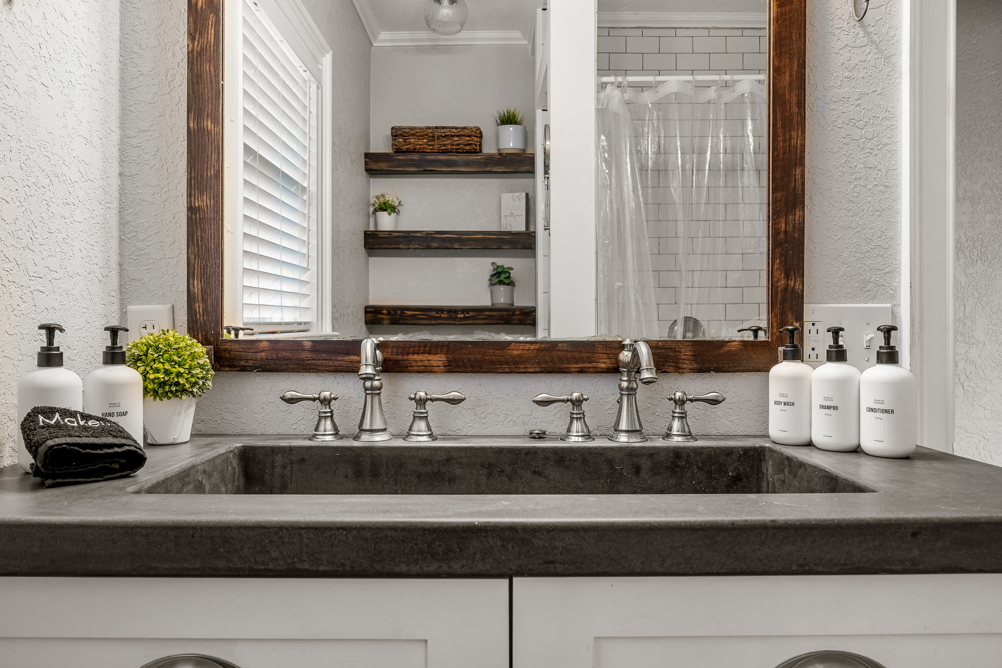 Full bathroom with dual sink and shower.
