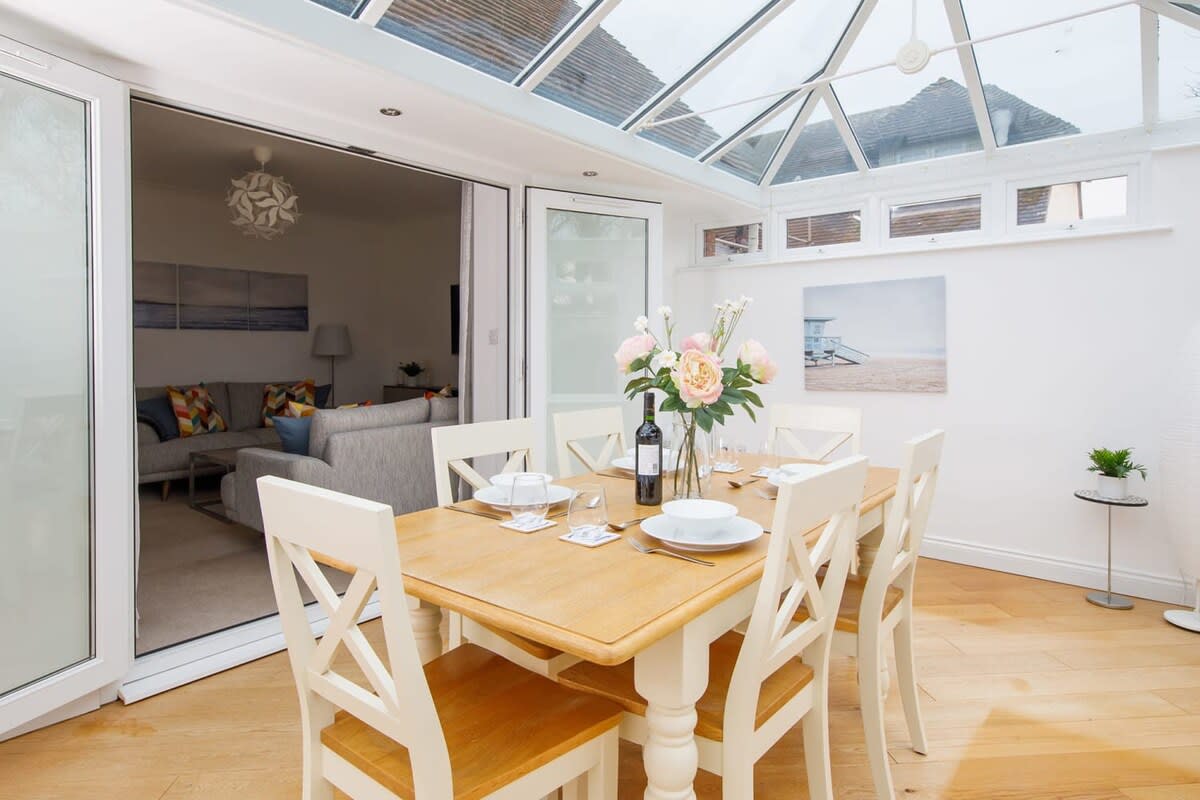 The light and bright conservatory is perfect as a breakfast room or for evening dining.