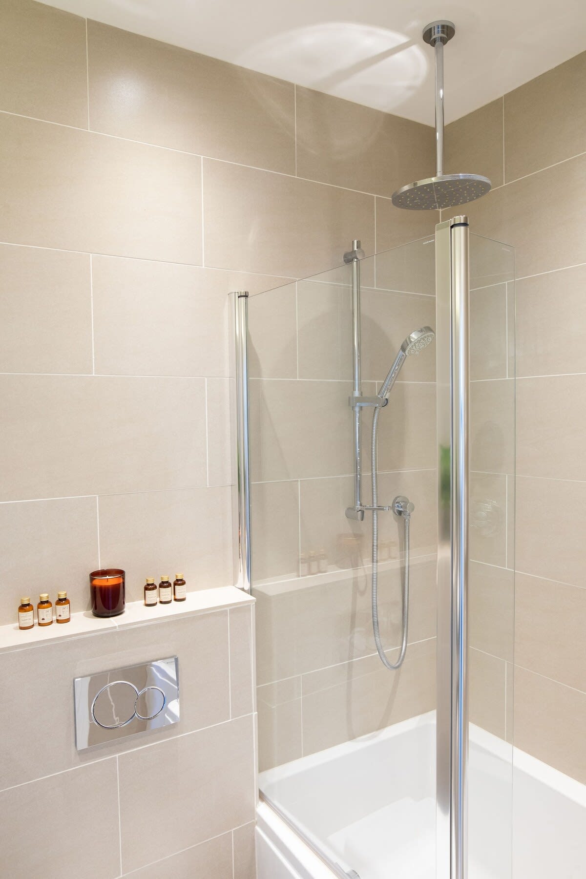 Rainfall shower over full sized bath.